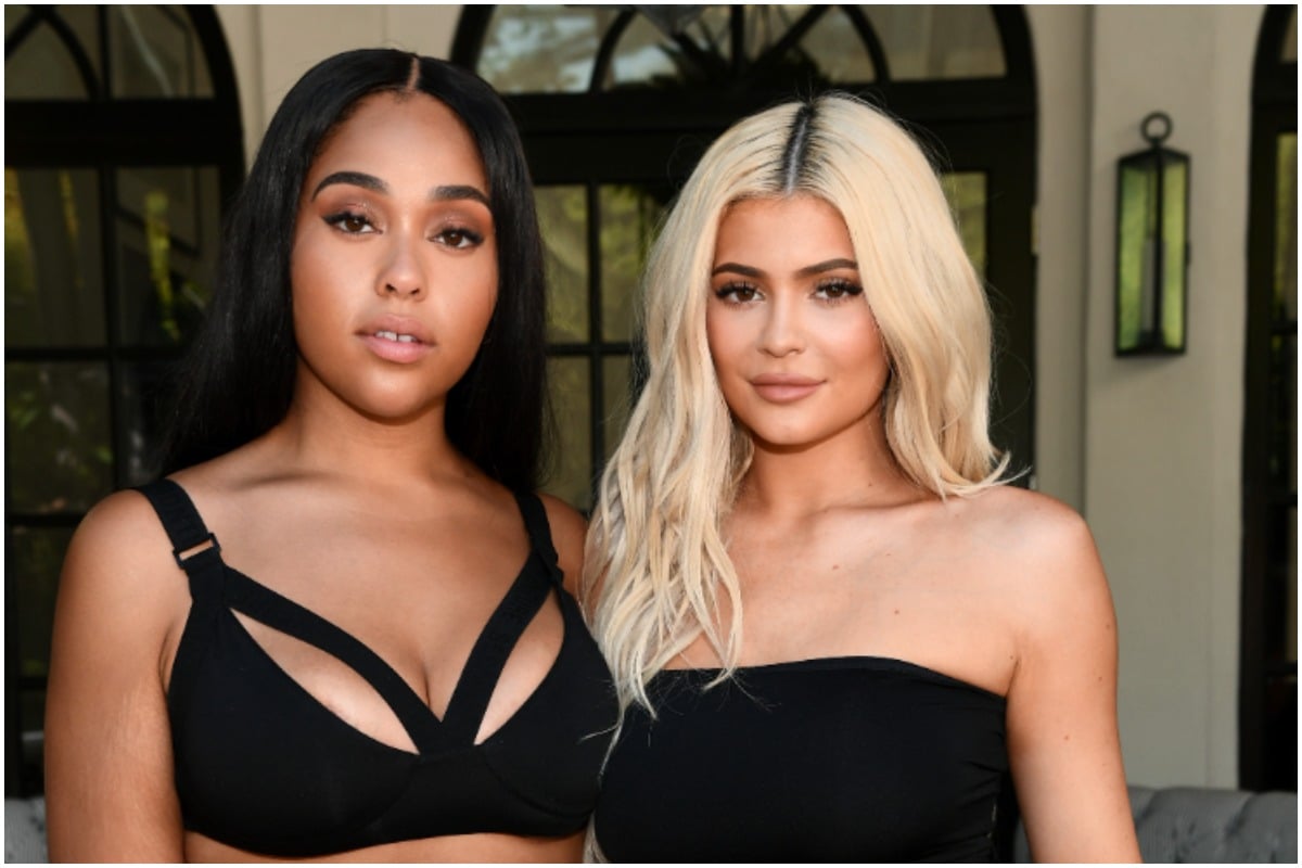 Jordyn Woods and Kylie Jenner wearing black outfits and smiling for the camera