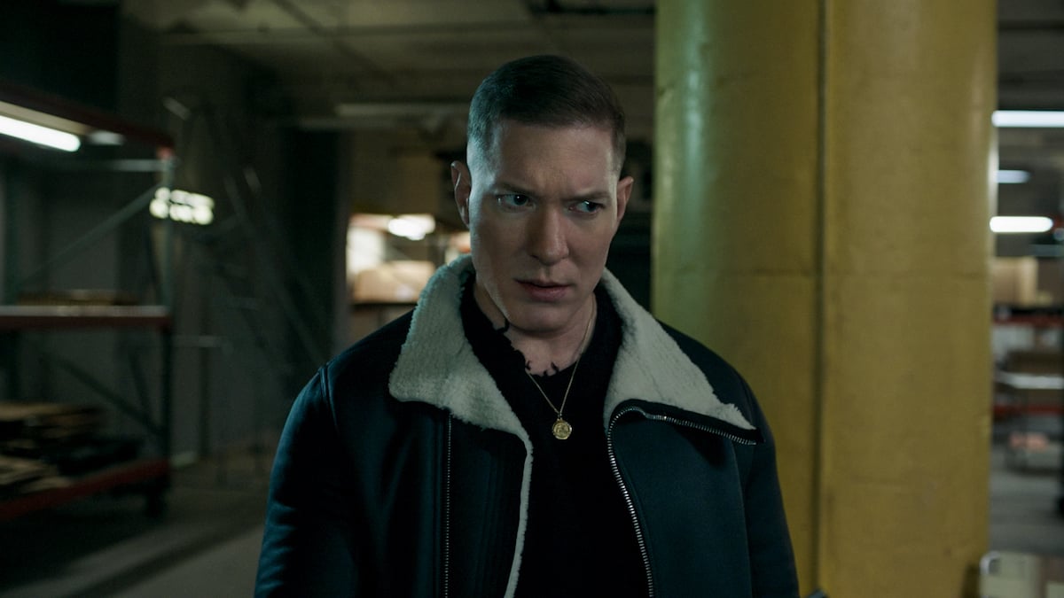 Joseph Sikora as Tommy Egan glaring while wearing a jacket and gold chain in 'Power