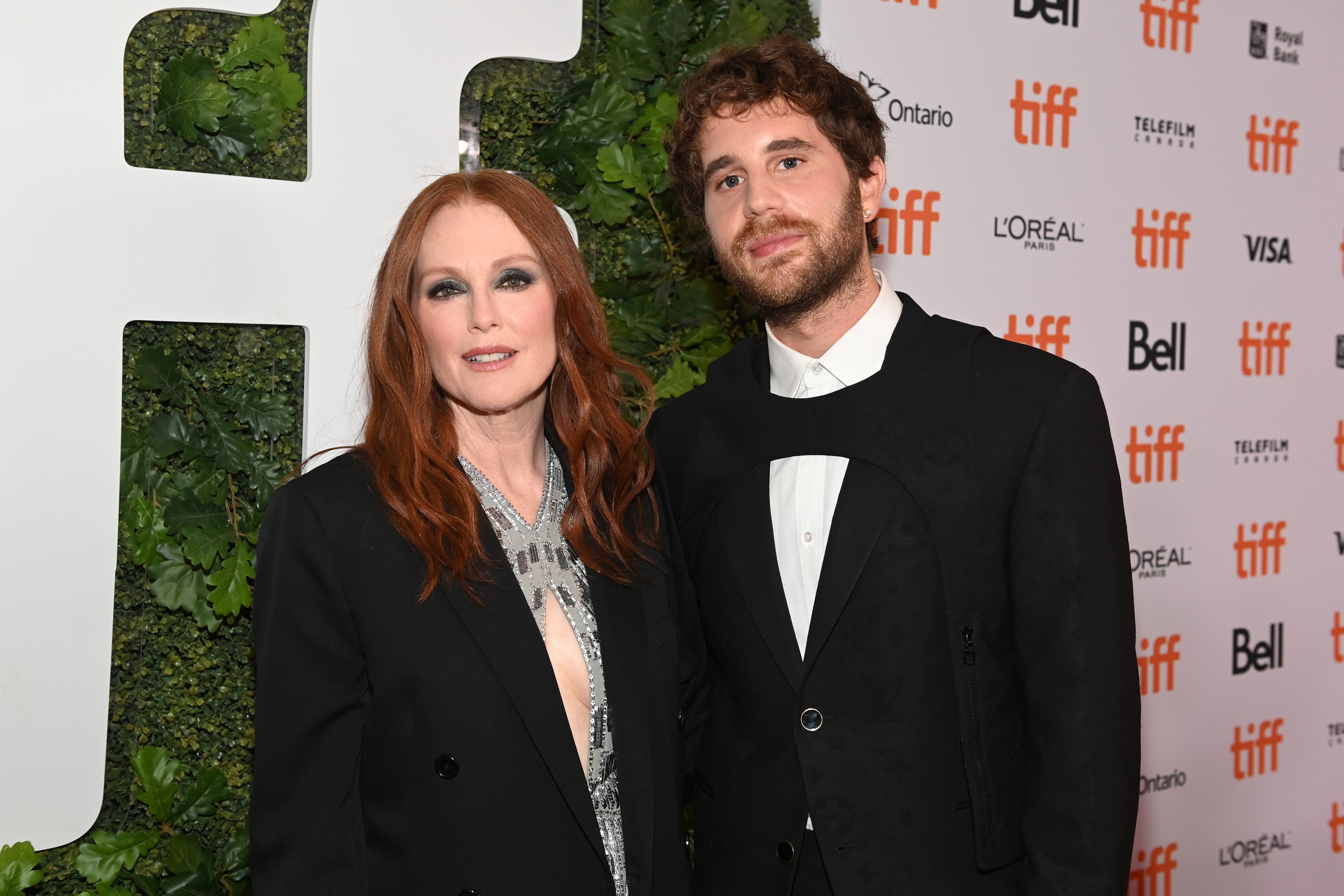 Julianne Moore, in a black jacket and grey dress, and Ben Platt in a black and white suit, attend the premiere of 'Dear Evan Hansen' at the Toronto International Film Festival in 2021.