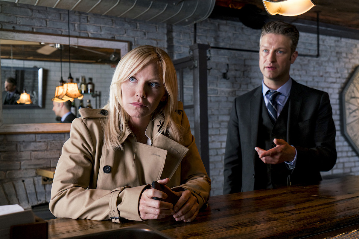 Kelli Giddish sitting and Peter Scanavino standing in 'Law & Order: SVU'