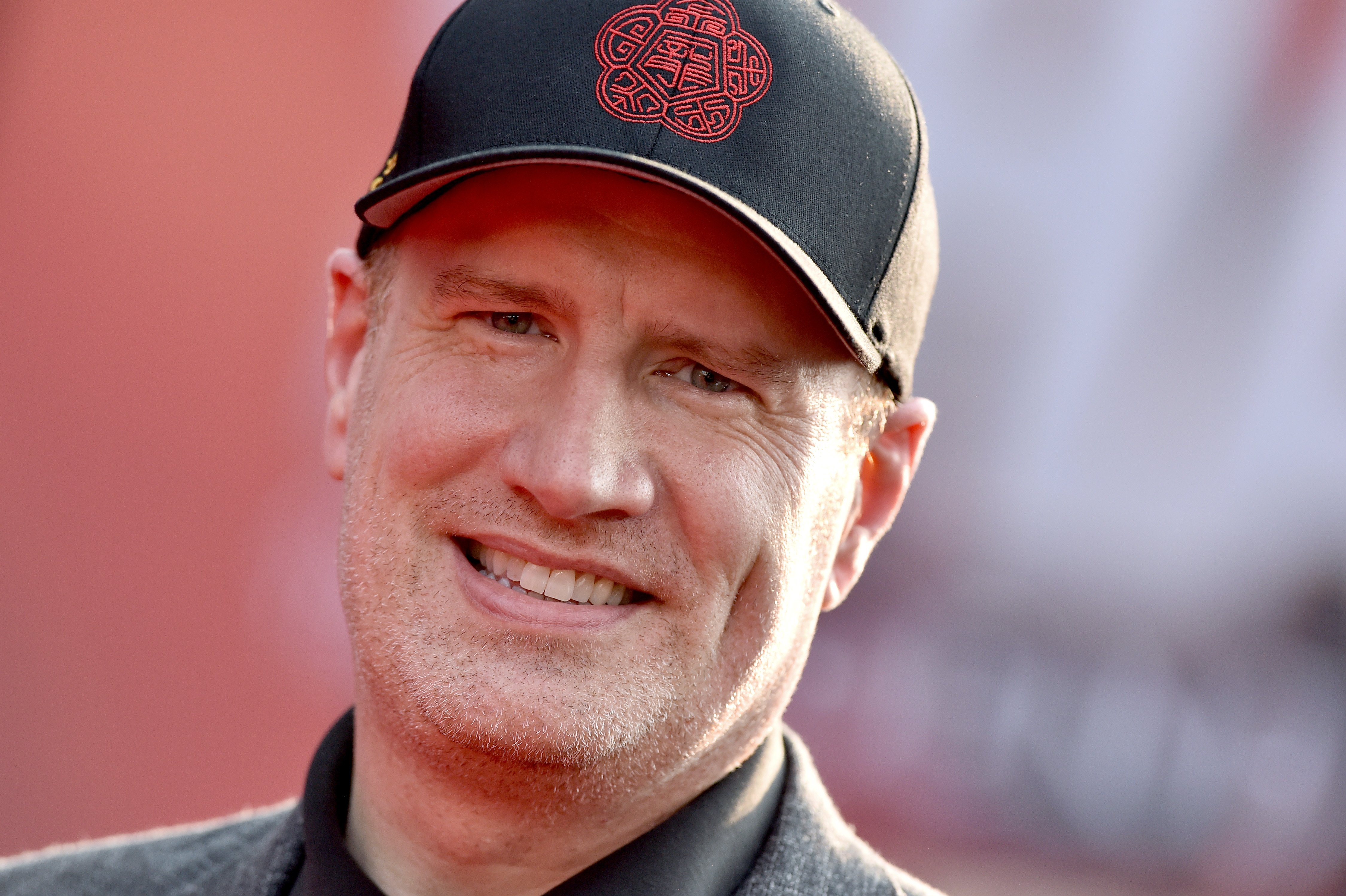 Kevin Feige smiles and wears a hat at the premiere of 'Shang-Chi and the Legend of the Ten Rings.'