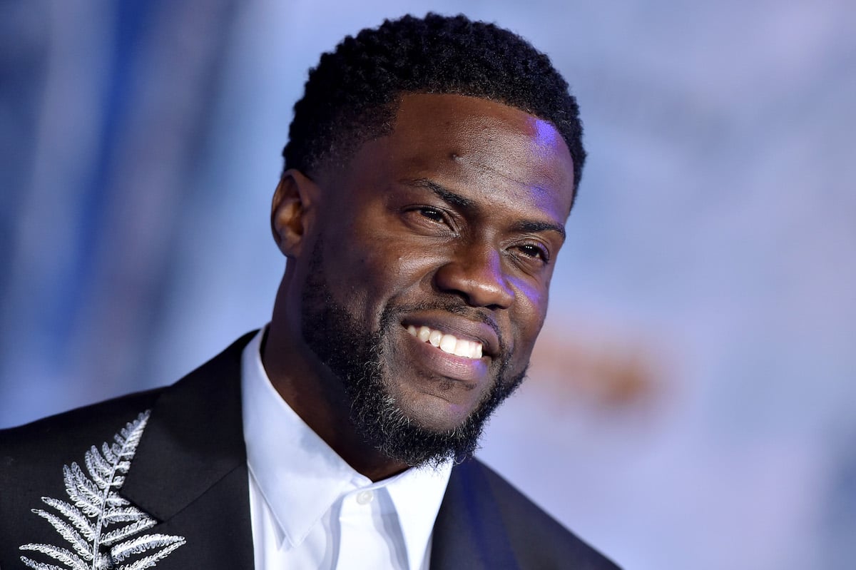 Kevin Hart on the red carpet in a black suit