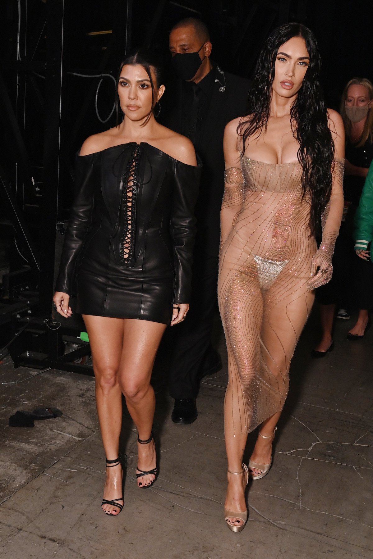 Kourtney Kardashian and Megan Fox walk together at the 2021 VMAs.