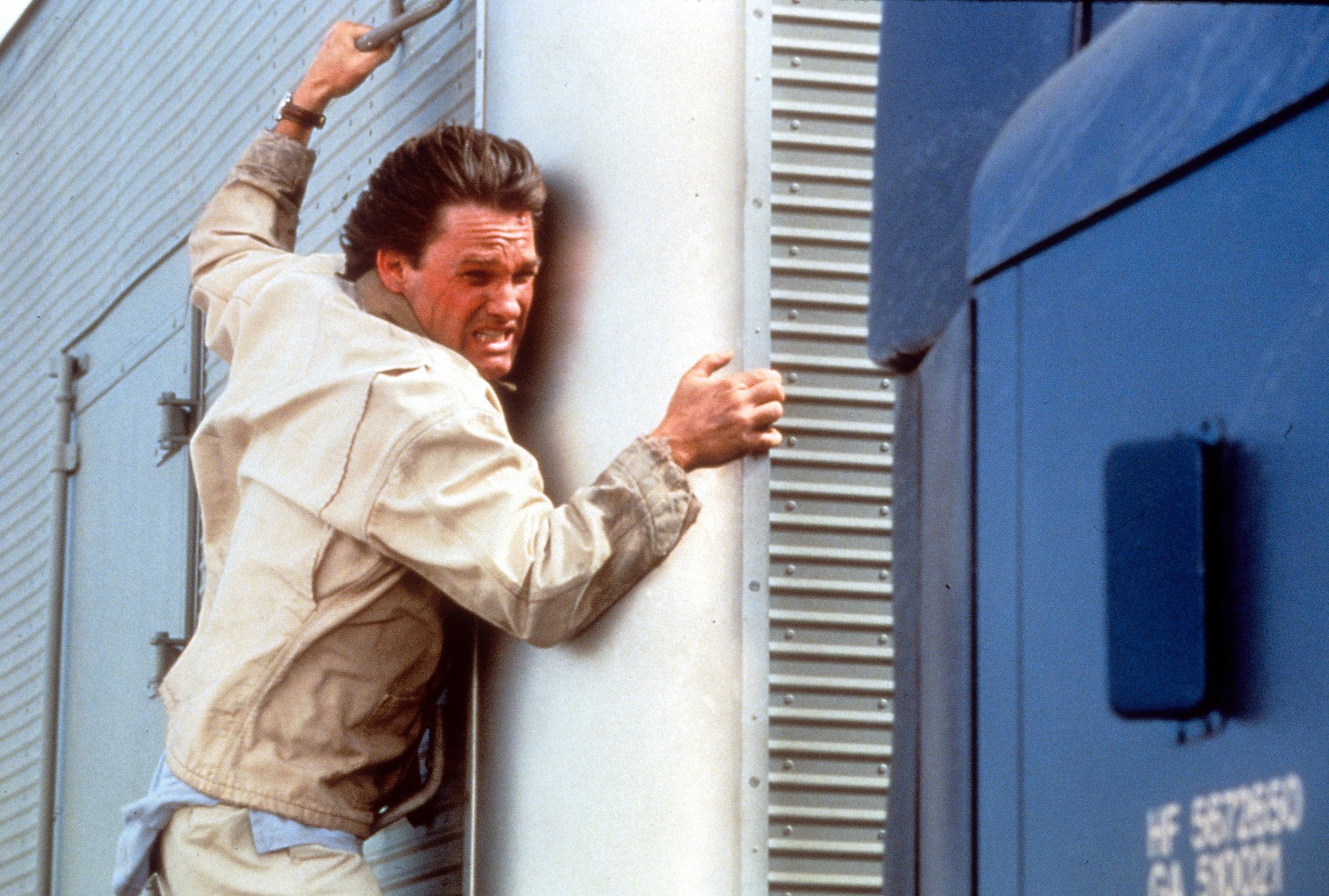 Kurt Russell hangs onto a truck in Breakdown