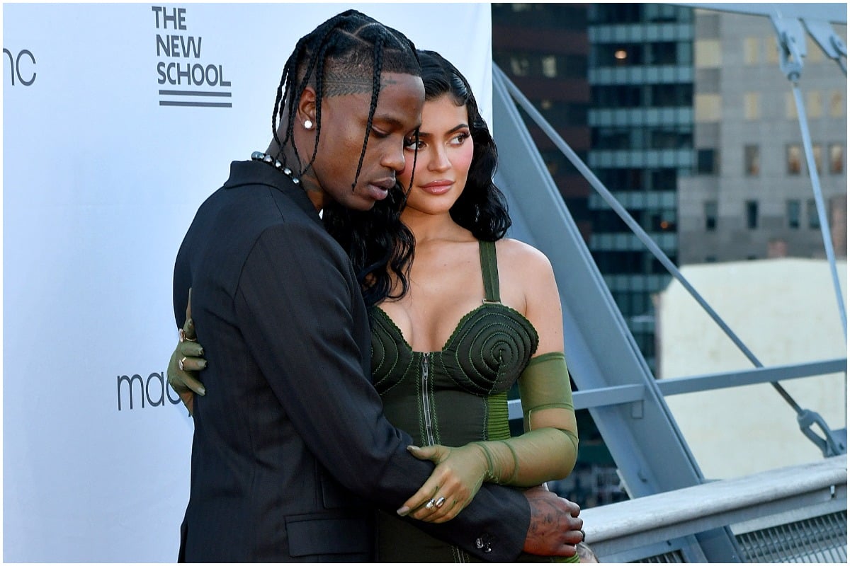 Kylie Jenner and Travis Scott hugging while attending a red carpet event