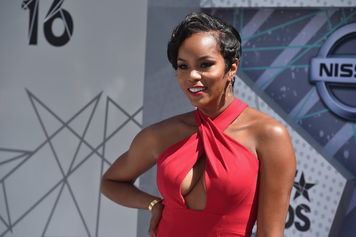Letoya Luckett smiling in a red dress on the BET Red Carpet