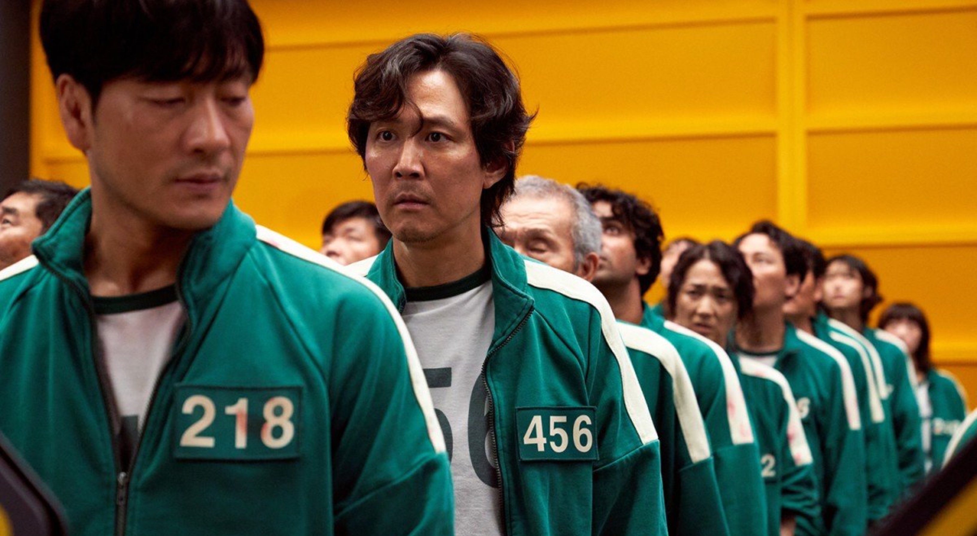 Lee Jung-Jae in Netflix's 'Squid Game' cast wearing green tracksuit in a line with other cast members
