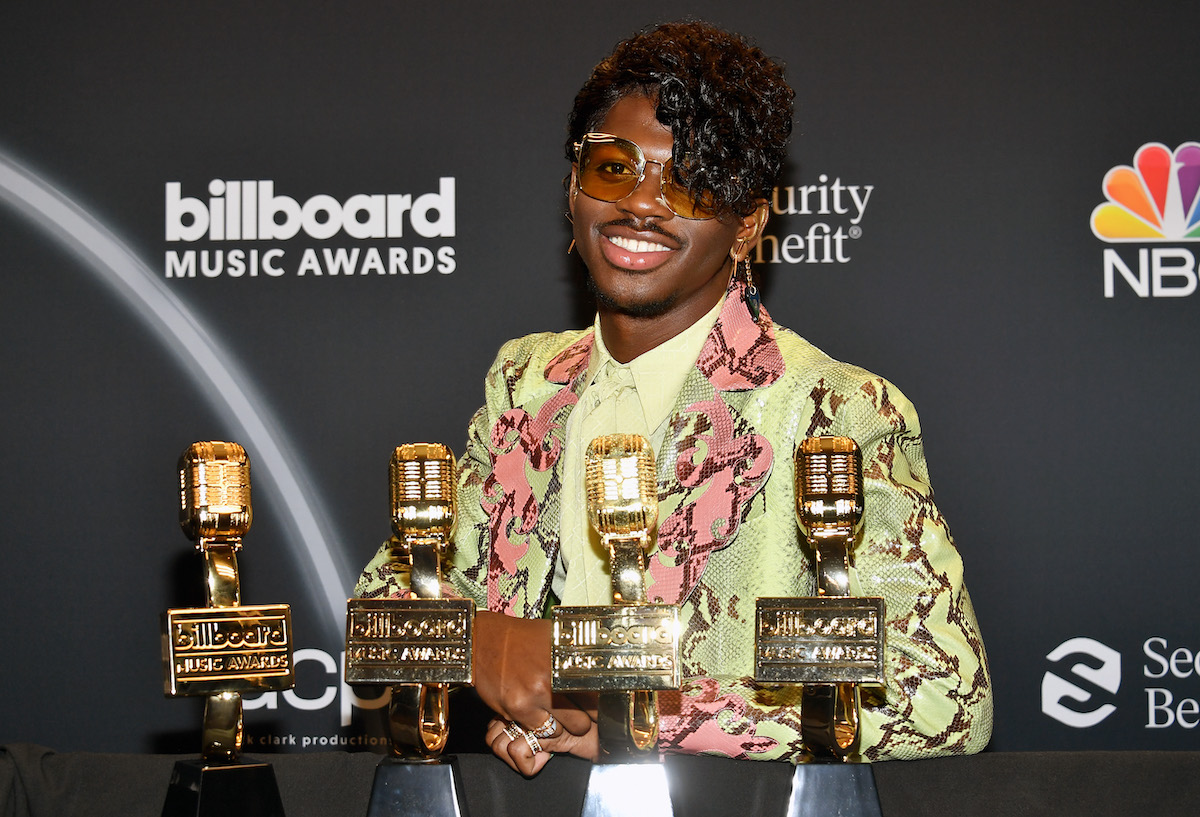Lil Nas X poses backstage with several awards at the 2020 Billboard Music Awards