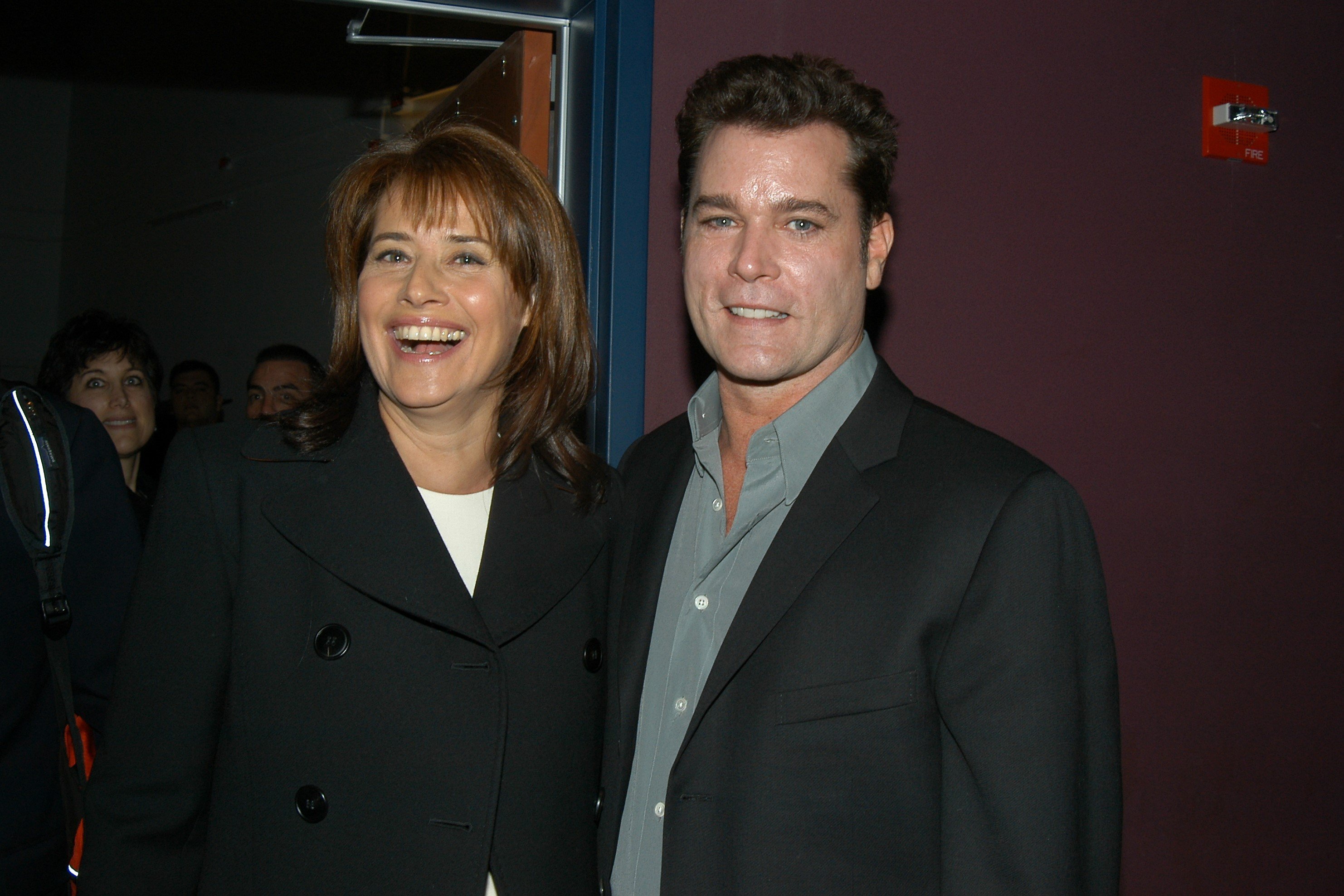 Lorraine Bracco, in a black jacket, and Ray Liotta, in a black suit jacket and grey shirt, at a screening of their movie 'Goodfellas' in 1990.