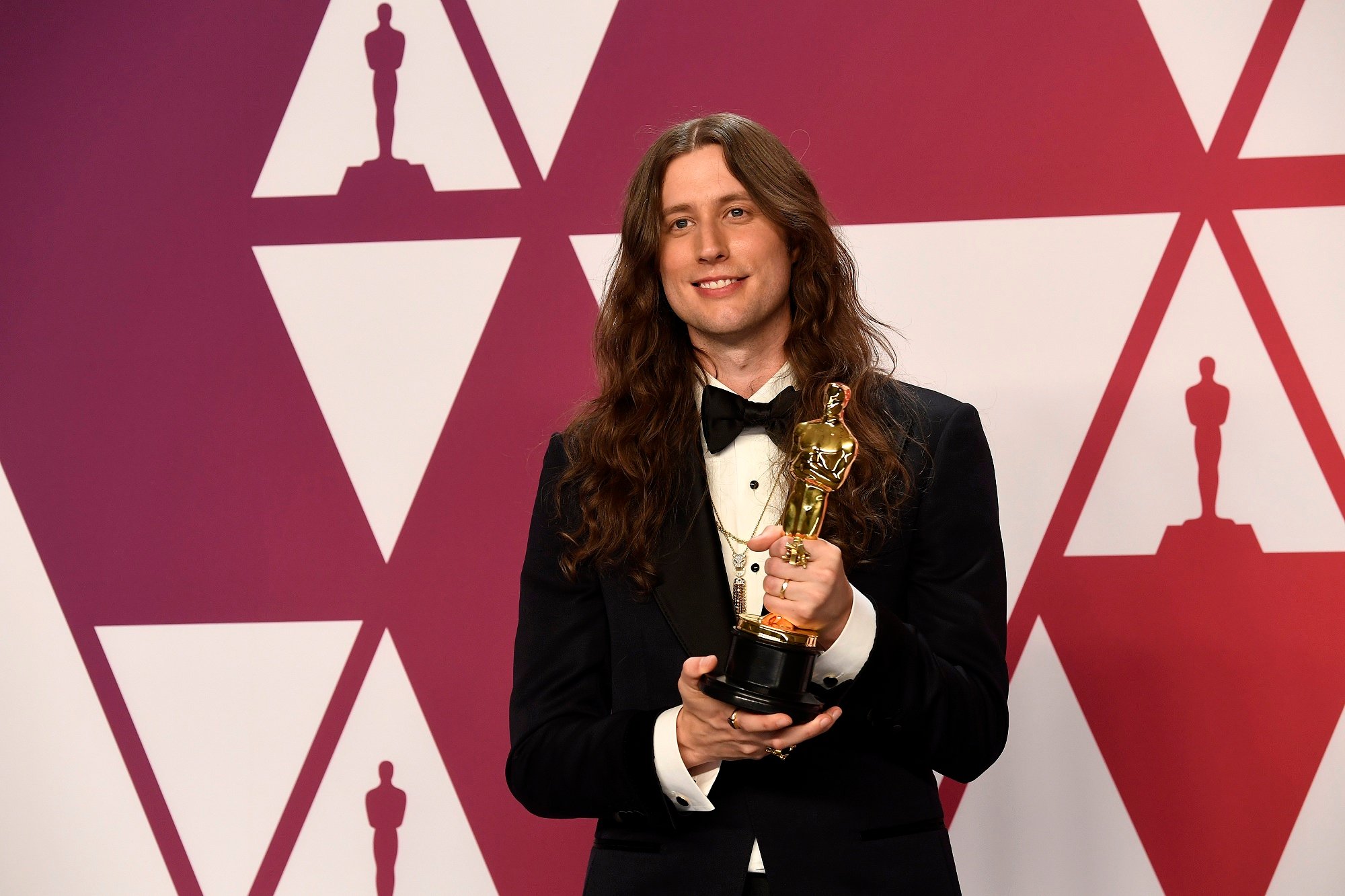 Composer Ludwig Göransson holds an Oscar statue in the Academy Awards press room