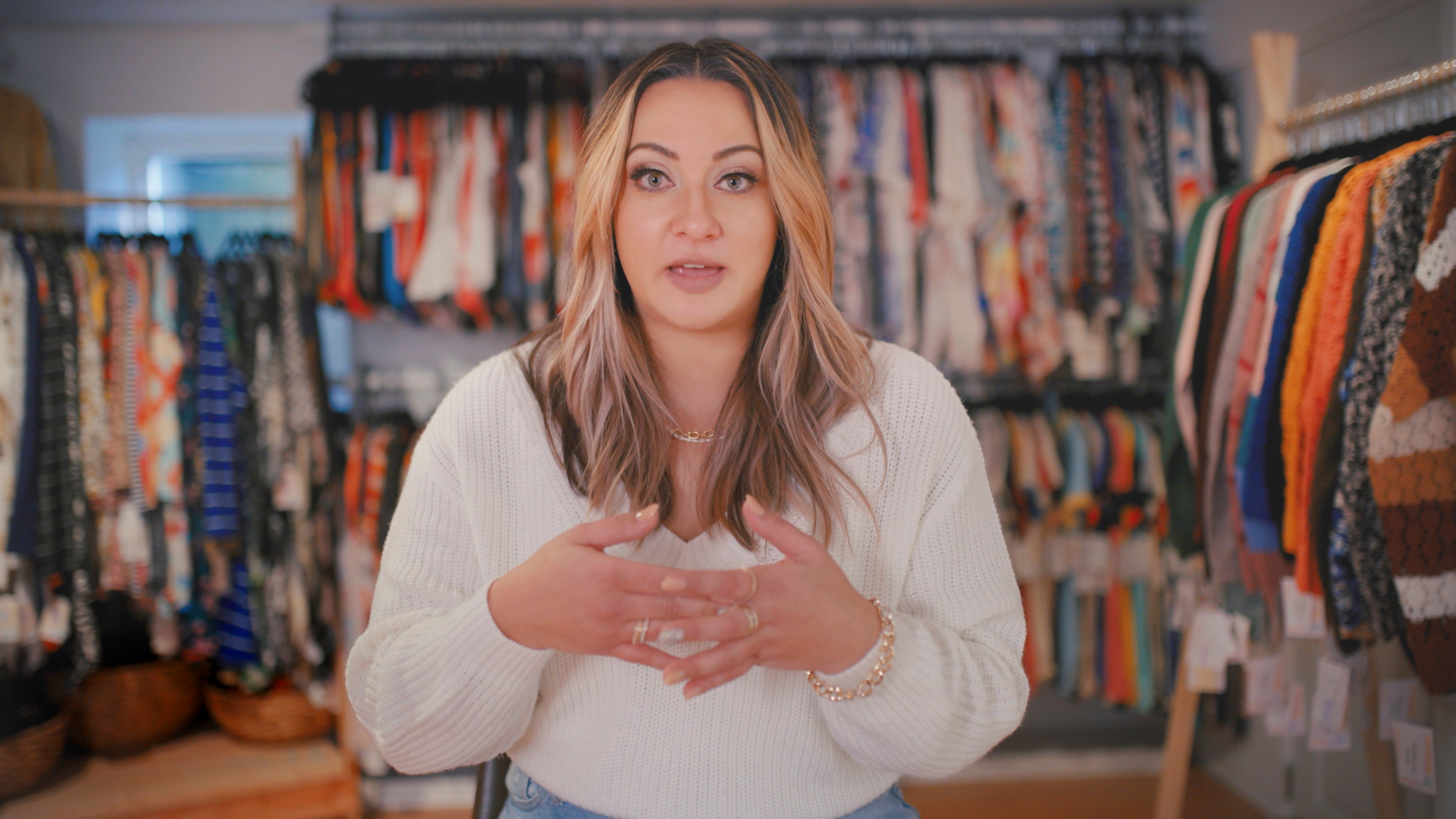 Former LulaRoe retailer in front of a roomful of clothing in LulaRich