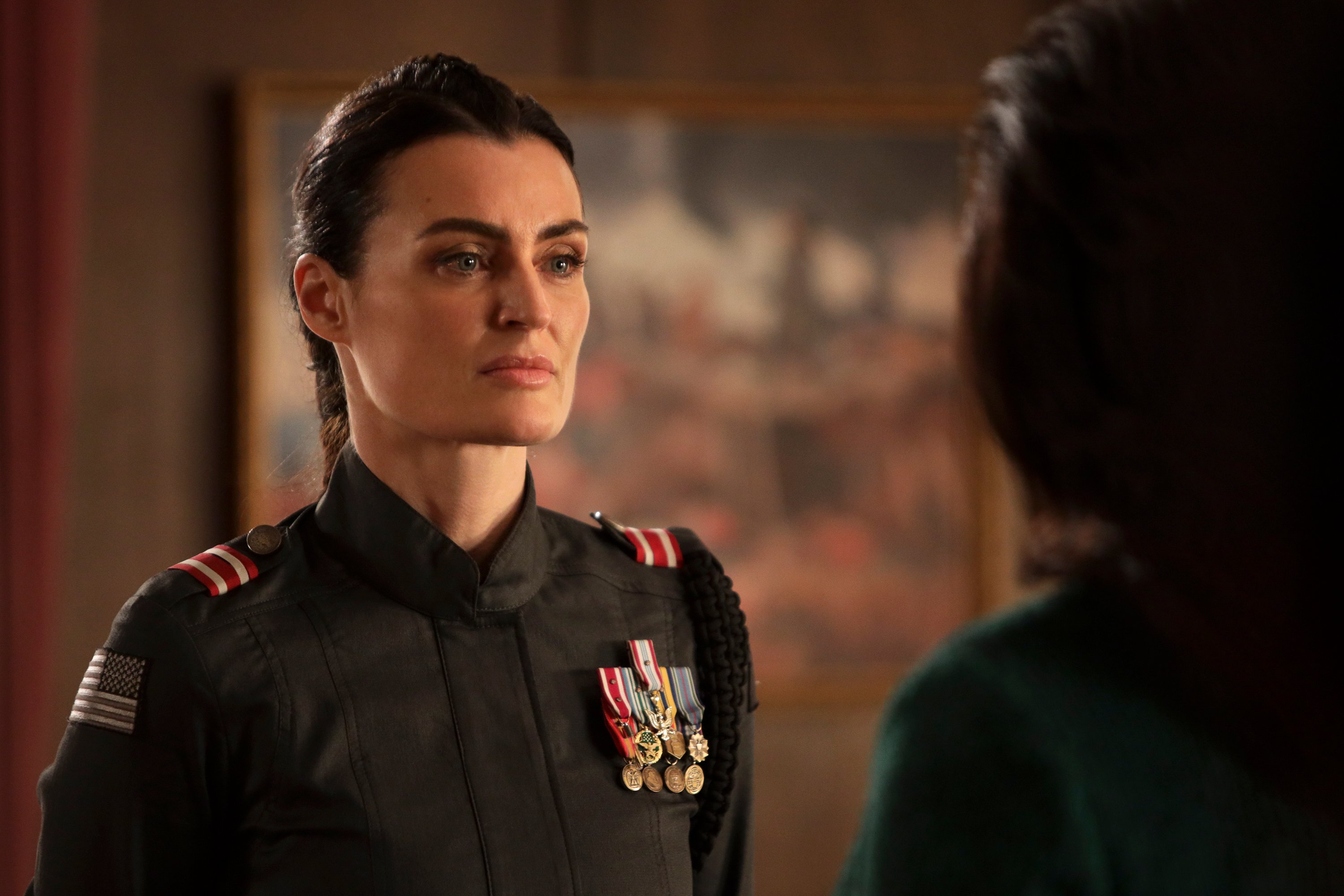 Lyne Renée as Sara Alder 'Motherland: Fort Salem' wearing military uniform and medals in Season 2