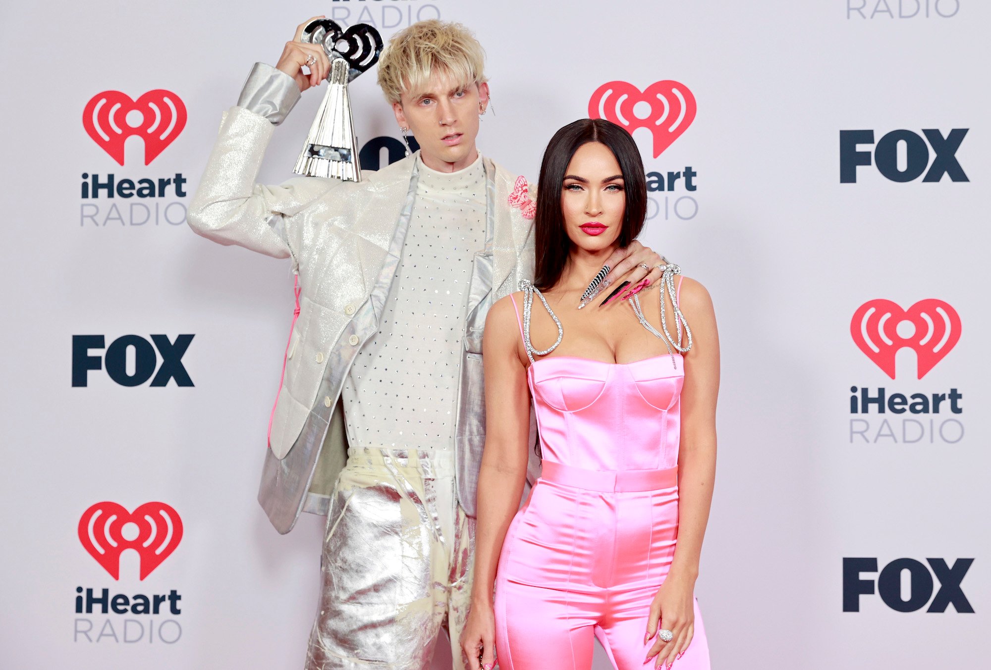 Machine Gun Kelly and Megan Fox posing together on the red carpet at the 2021 iHeartRadio Music Awards