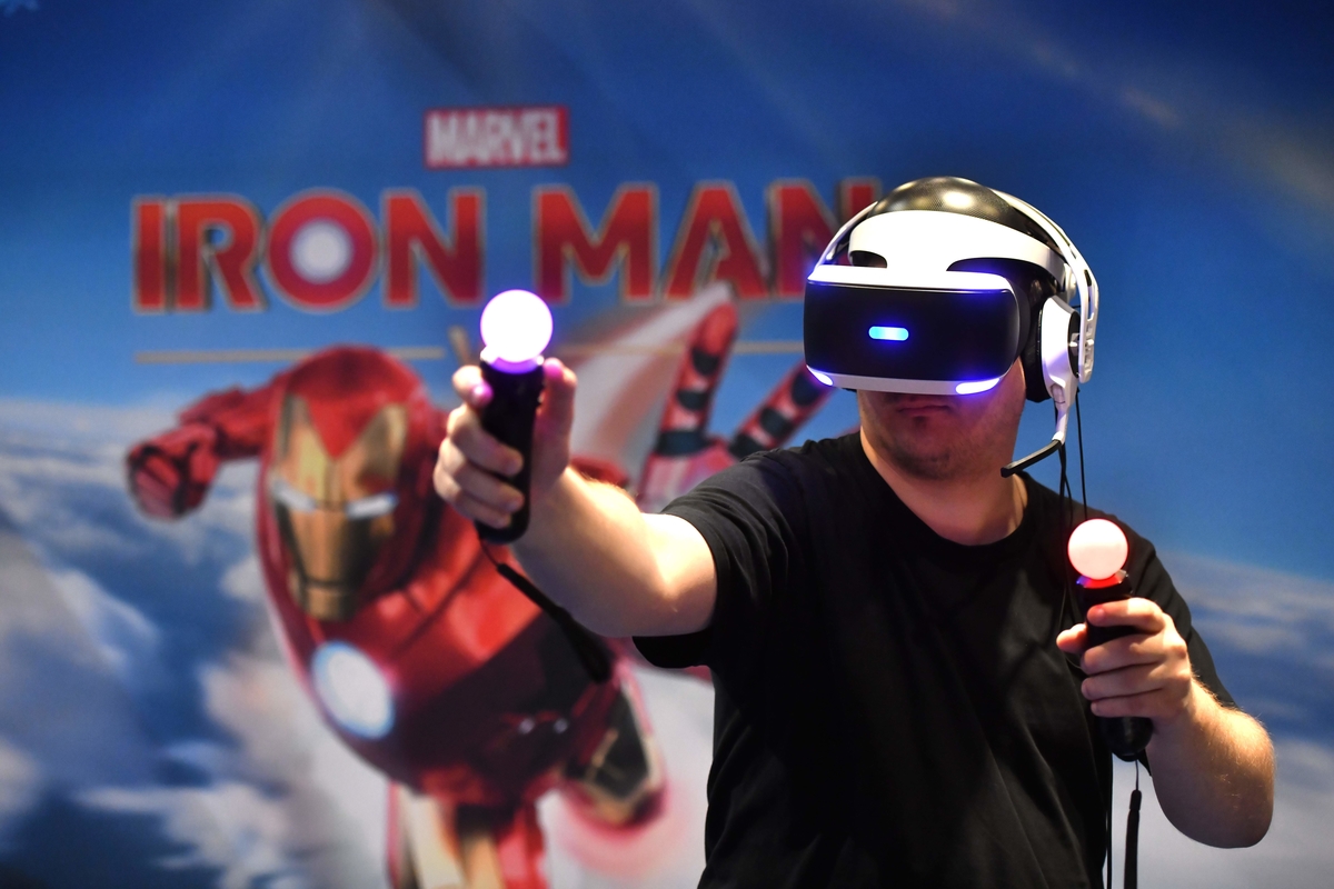 A visitor plays "Marvel - Iron Man" at Playstation stand at Gamescom