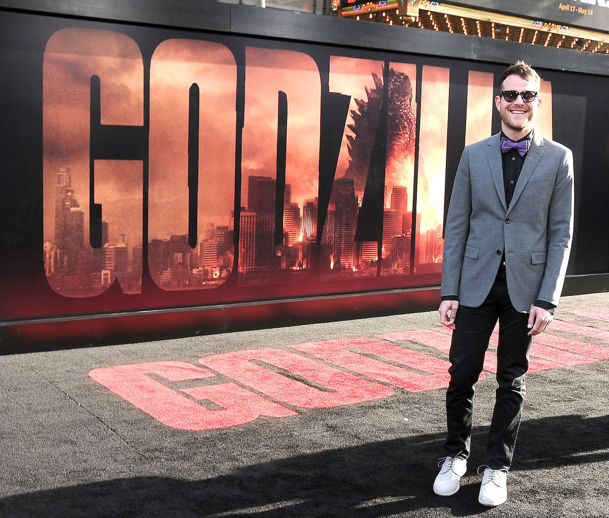 Max Borenstein in front of Godzilla poster.