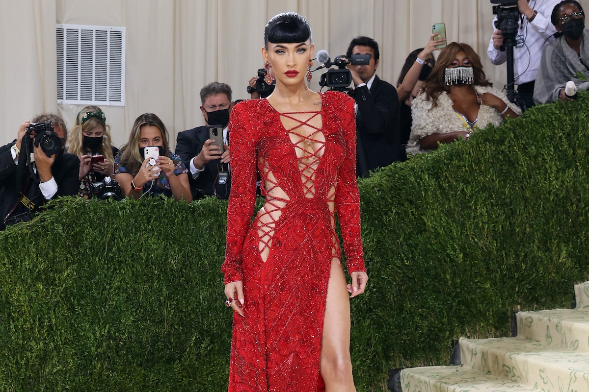 Megan Fox in a strappy red dress and blunt black bangs at the 2021 Met Gala.