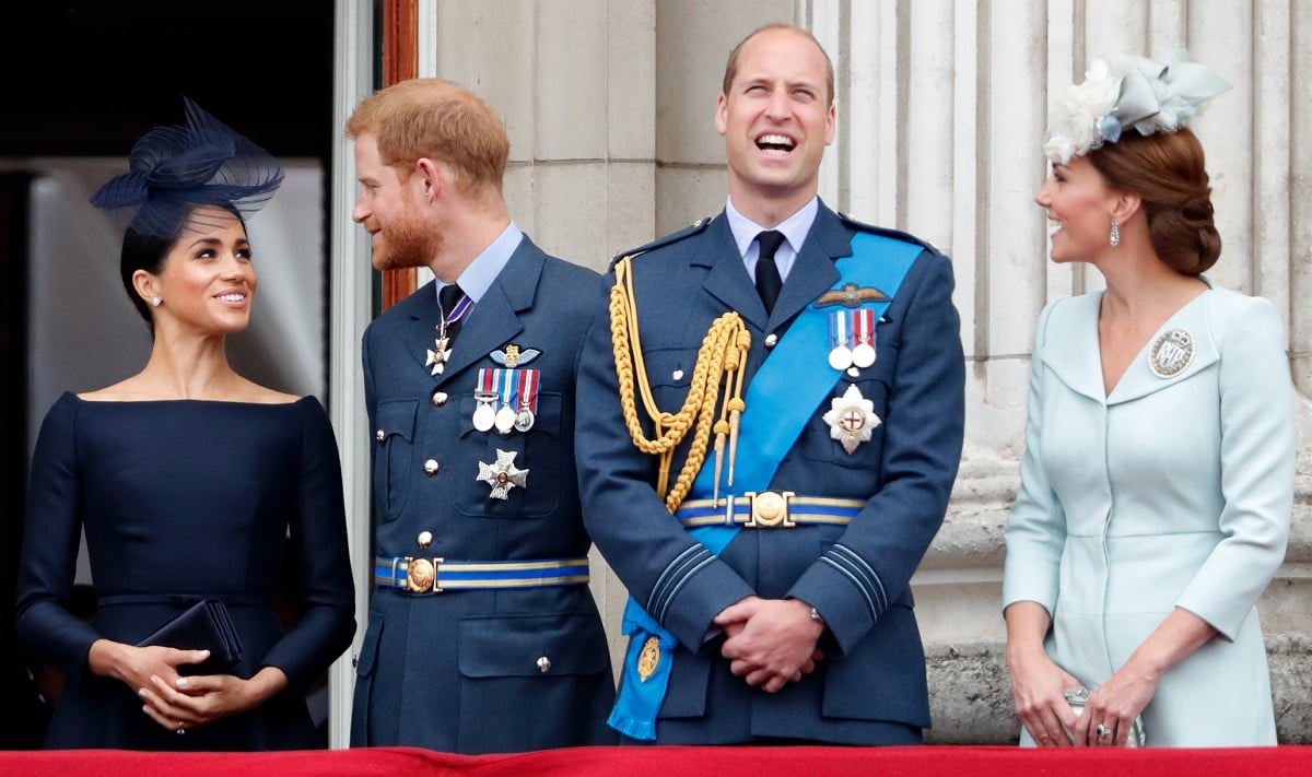 Meghan Markle, Prince Harry, Prince William, and Kate Middleton standing on the balcony of Buckingham Palace