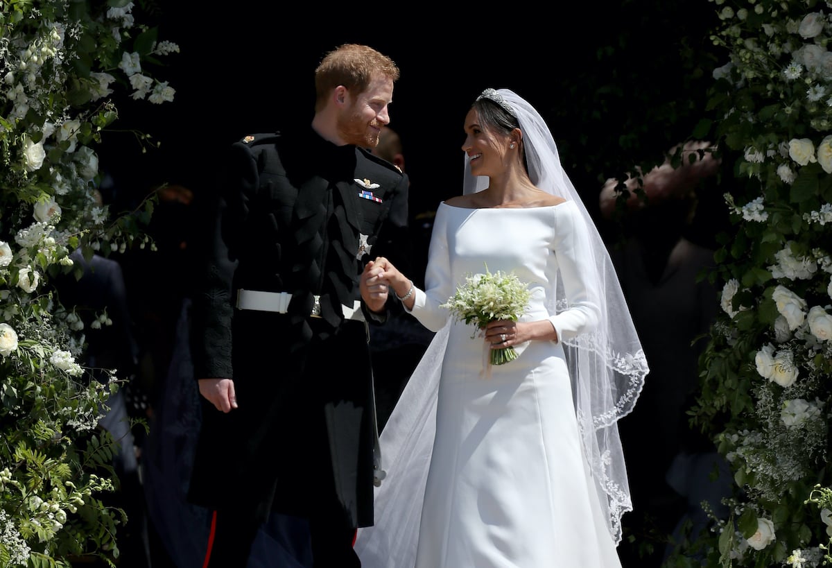 Meghan Markle wedding photo with Prince Harry (L) smiling at Meghan, Duchess of Sussex (R)