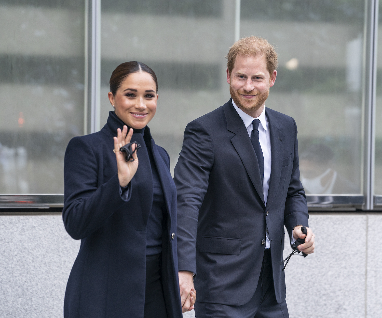 Meghan Markle waves as she and Prince Harry arrive at One World Observatory in New York City hand-in-hand in September 2021