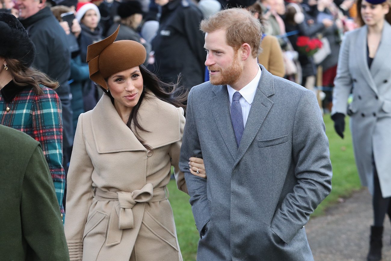 Meghan Markle and Prince Harry walk together as they arrive for church services on Christmas Day in 2017