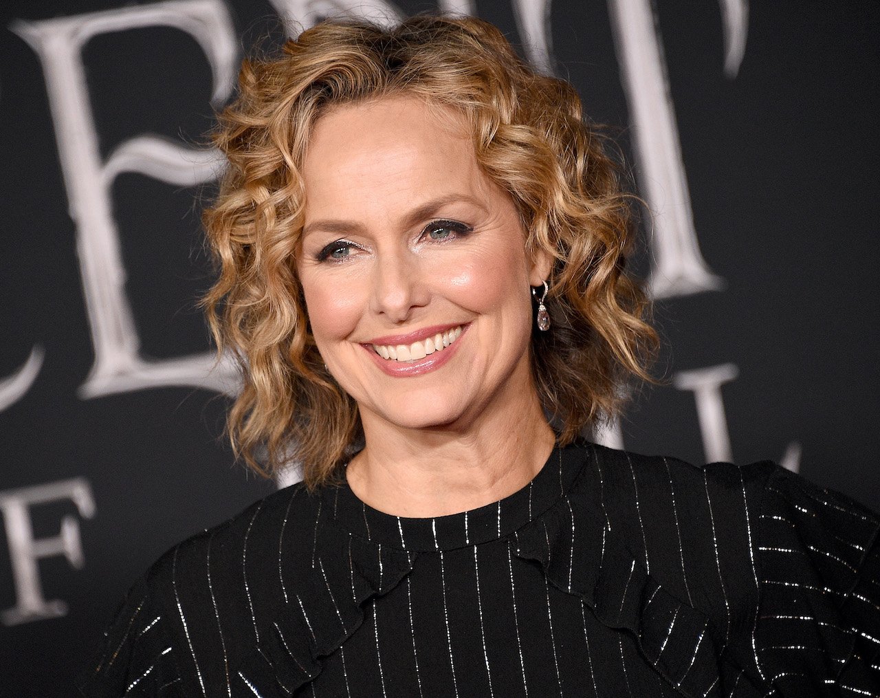 Melora Hardin smiles for cameras as she arrives at the World Premiere Of Disney's 'Maleficent: Mistress Of Evil' at El Capitan Theatre