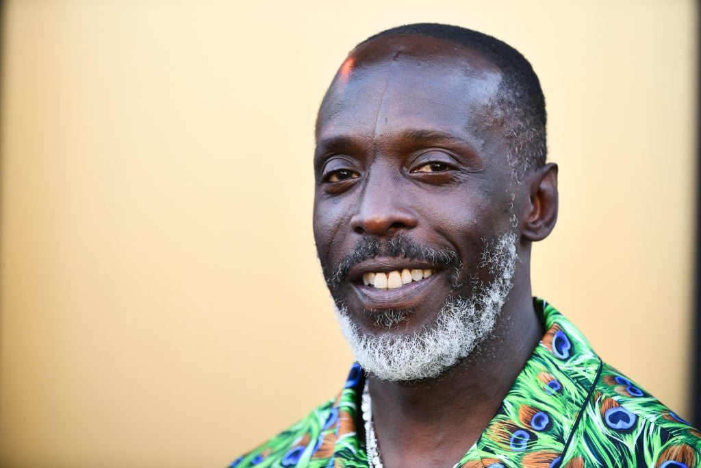 'Lovecraft Country' star Michael K. Williams, dressed in a green shirt, walks the red carpet, all smiles.