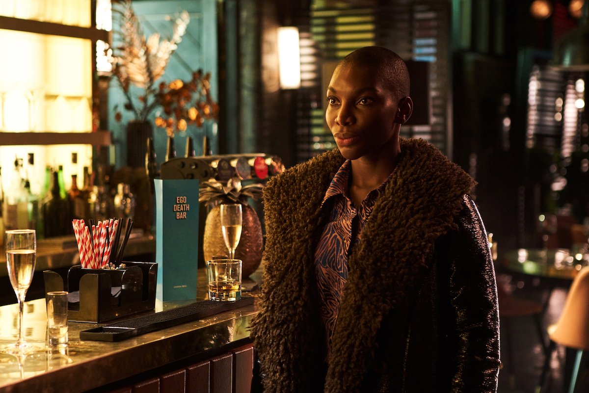 Michaela Coel standing next to a bar in 'I May Destroy You.'