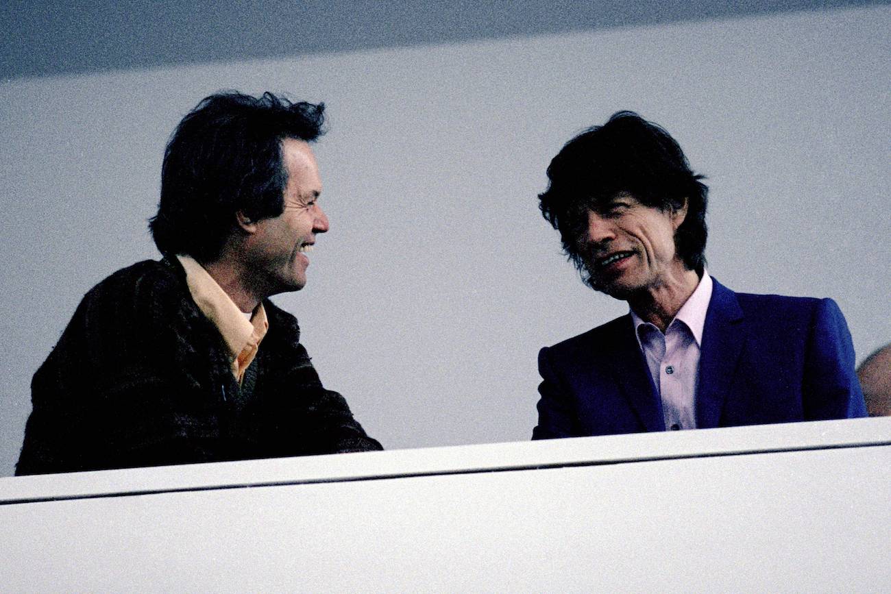 Mick and Chris Jagger talking to each other.