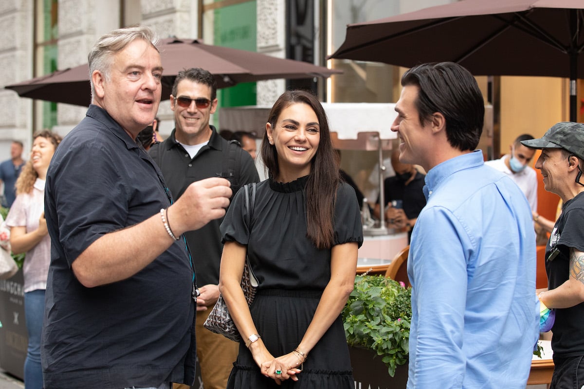 Mike Barker, Mila Kunis, and Finn Wittrock laugh together while filming a scene.