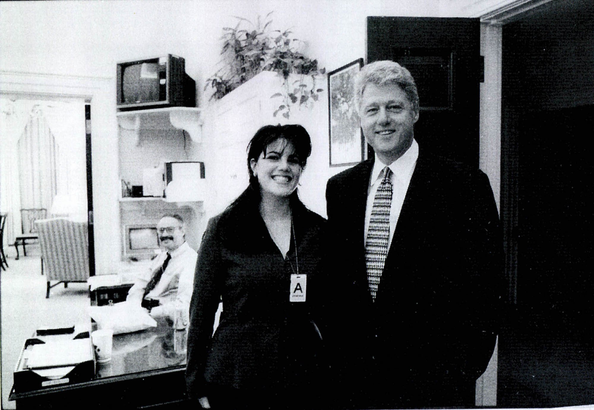 Monica Lewinsky posing next to Bill Clinton inside the White House