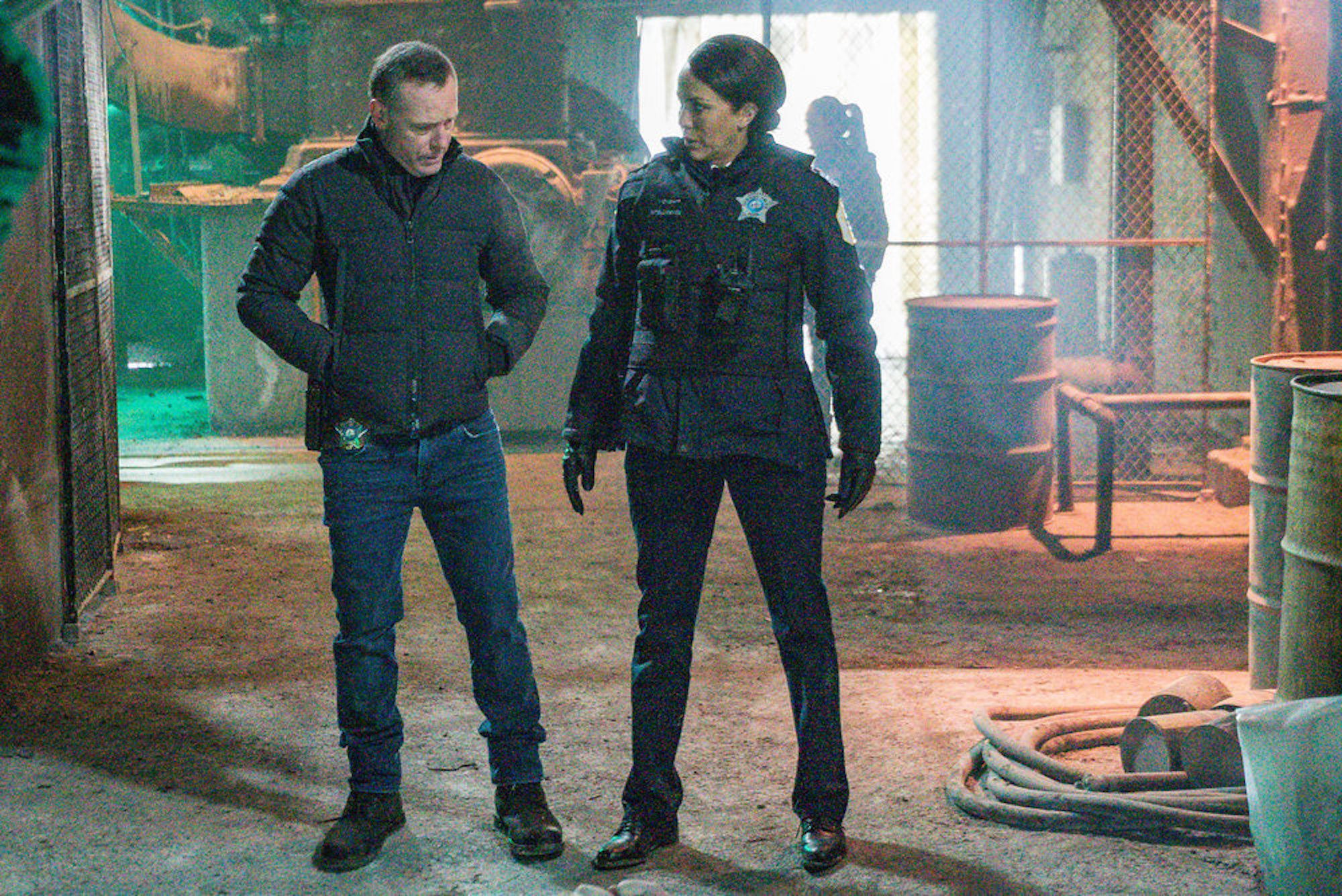 Hank Voight and Samantha Miller from 'Chicago P.D.' Season 9 standing together at a crime scene