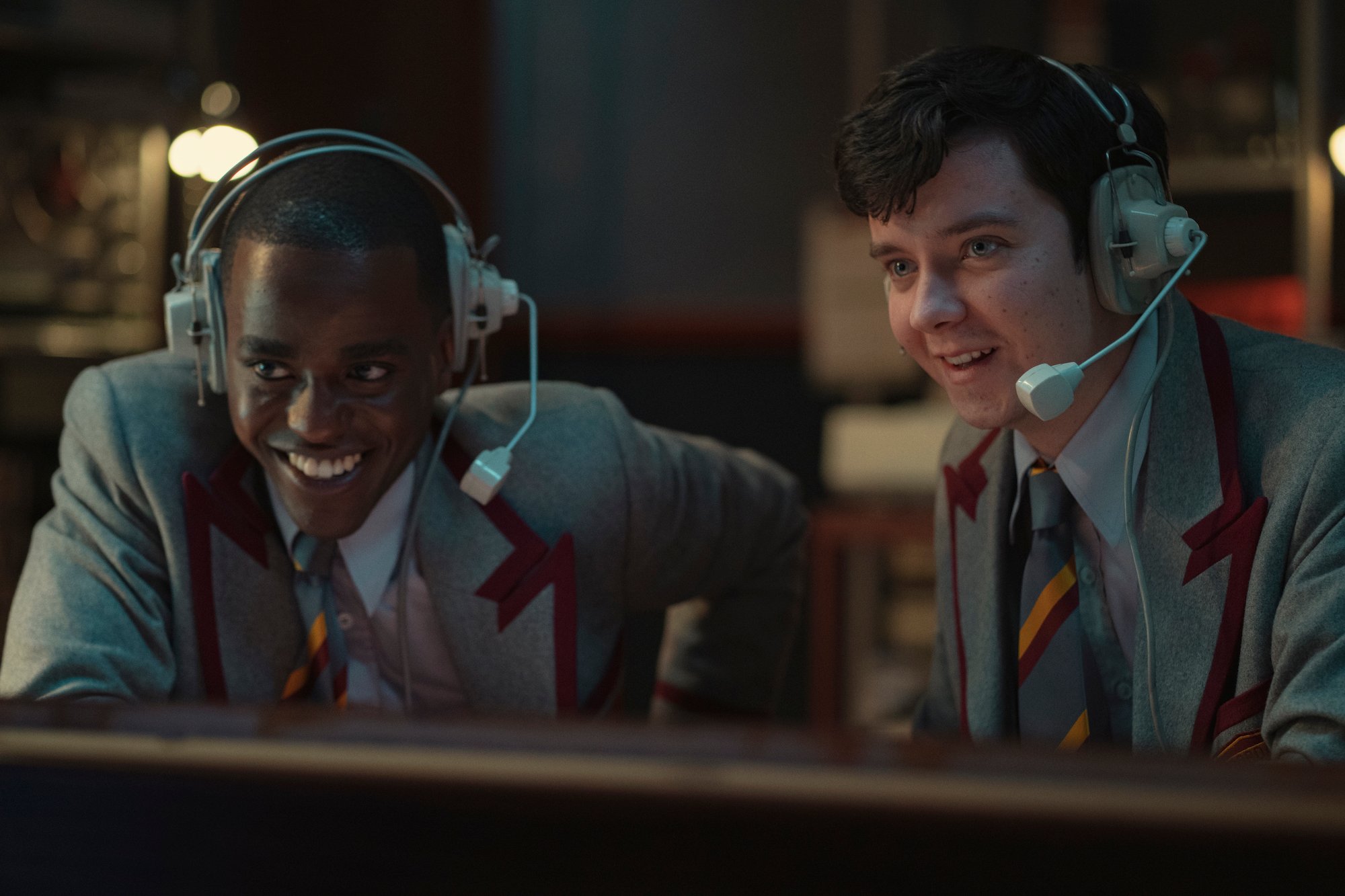 Ncuti Gatwa, and Asa Butterfield wearing headsets in a radio station in 'Sex Education' Season 3. 
