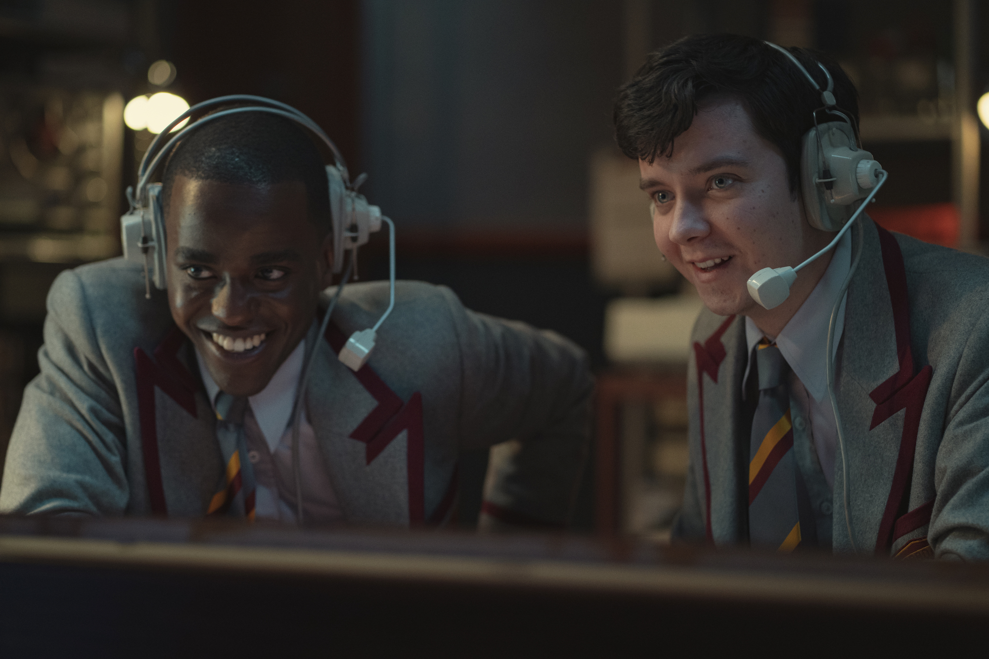 Ncuti Gatwa, and Asa Butterfield wearing headsets in a radio station in 'Sex Education' Season 3.