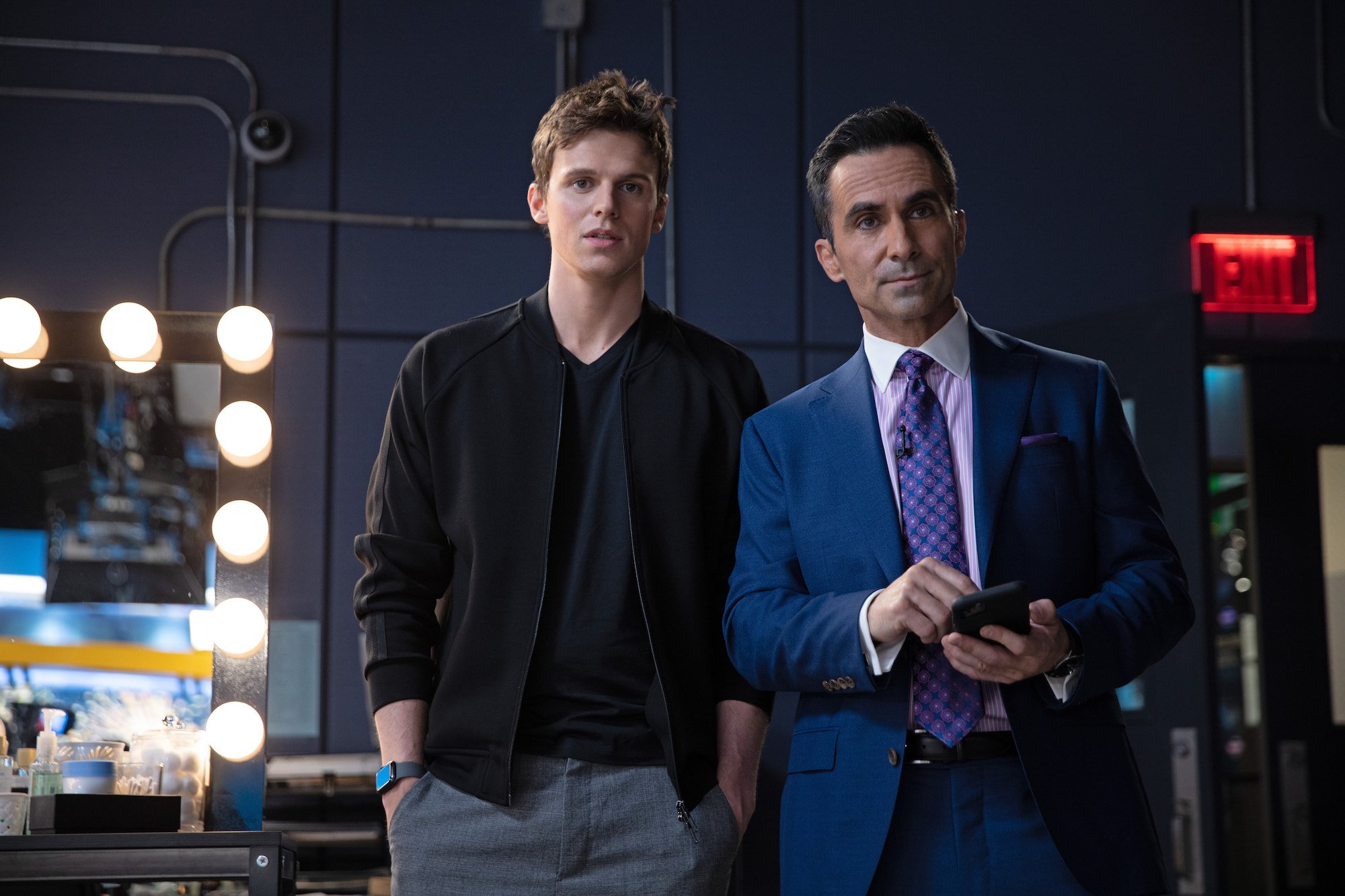 Nestor Carbonell and Ruairi O'Connor stand backstage