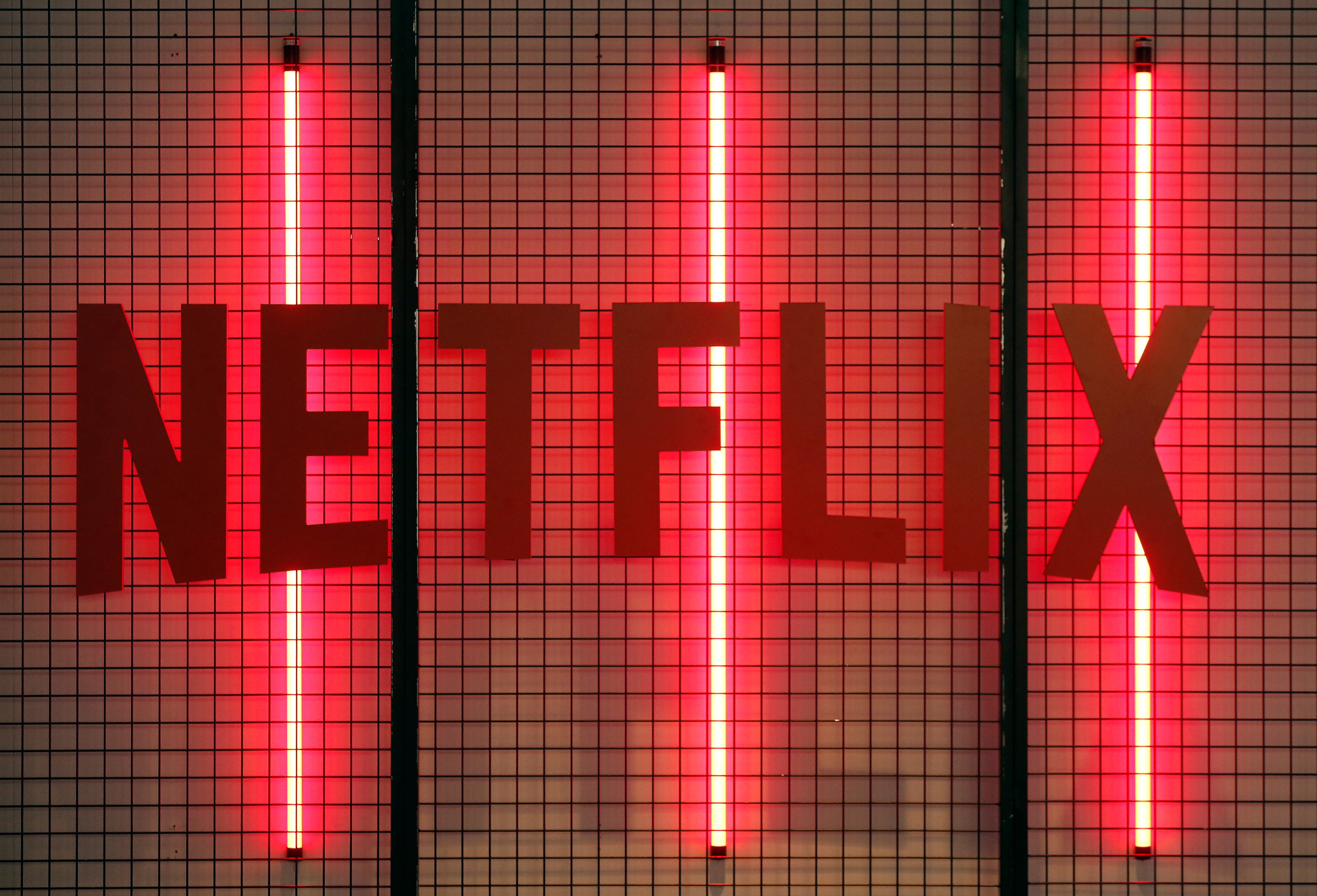 Netflix logo shining lights behind it as it debuts new horror movies in 2021 like Night Teeth, There's Someone Inside Your House,' and Fever Dream