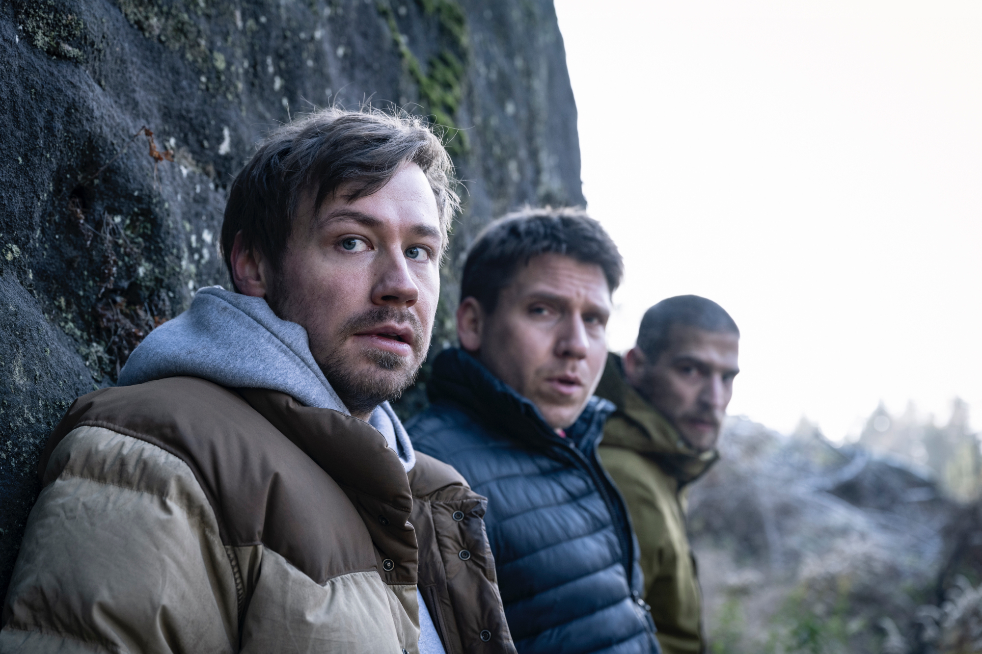 Netflix's 'Prey' actors David Kross, Hanno Koffler, and Robert Finster hiding from the killer