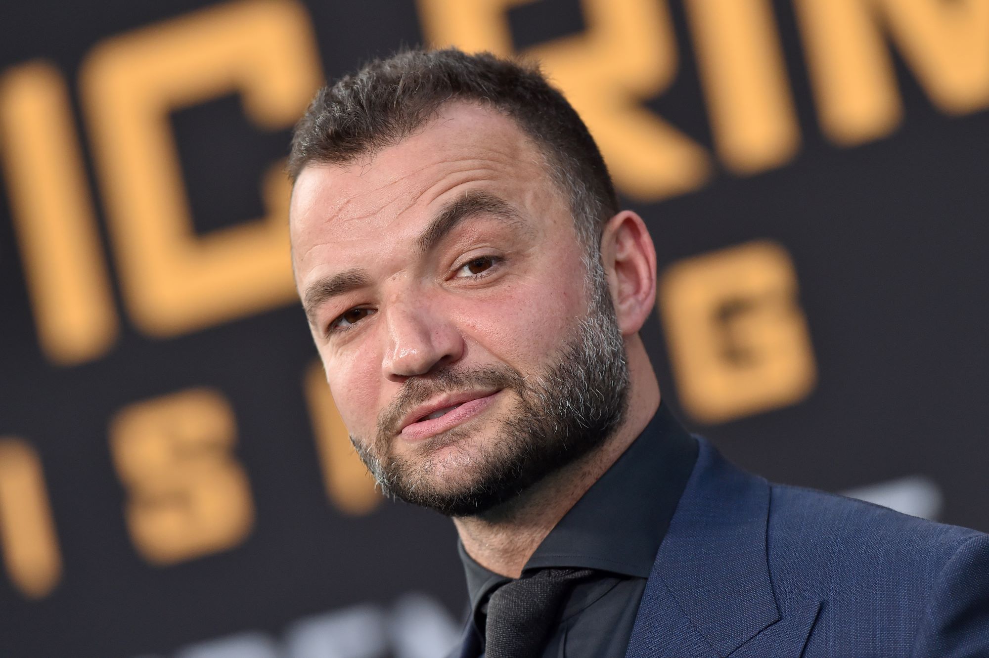 Nick Tarabay wears a suit and sports a beard.