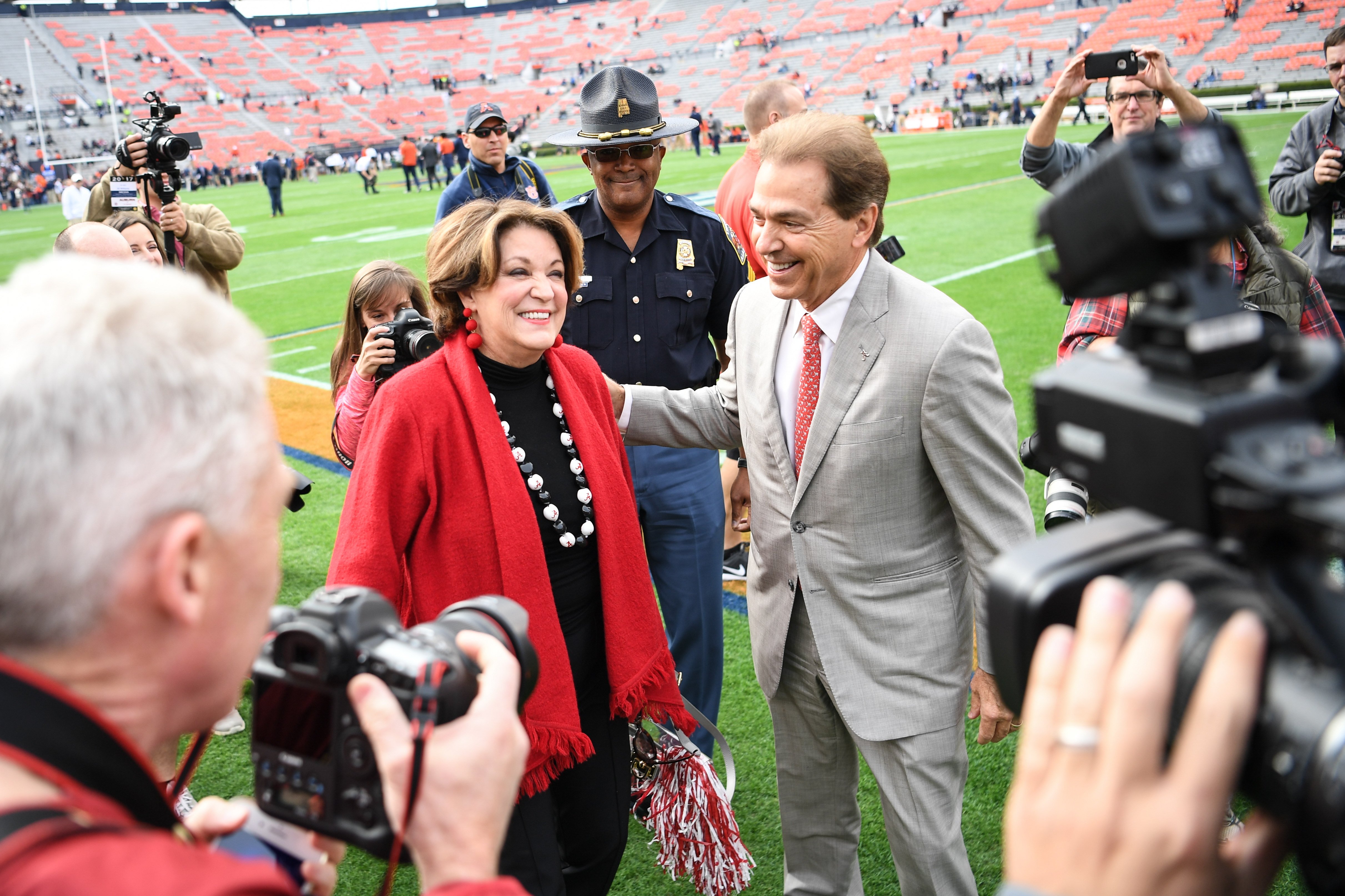 Nick Saban greets wife Terry on the sidelines prior to a football game between the Auburn Tigers and the Alabama Crimson Tide