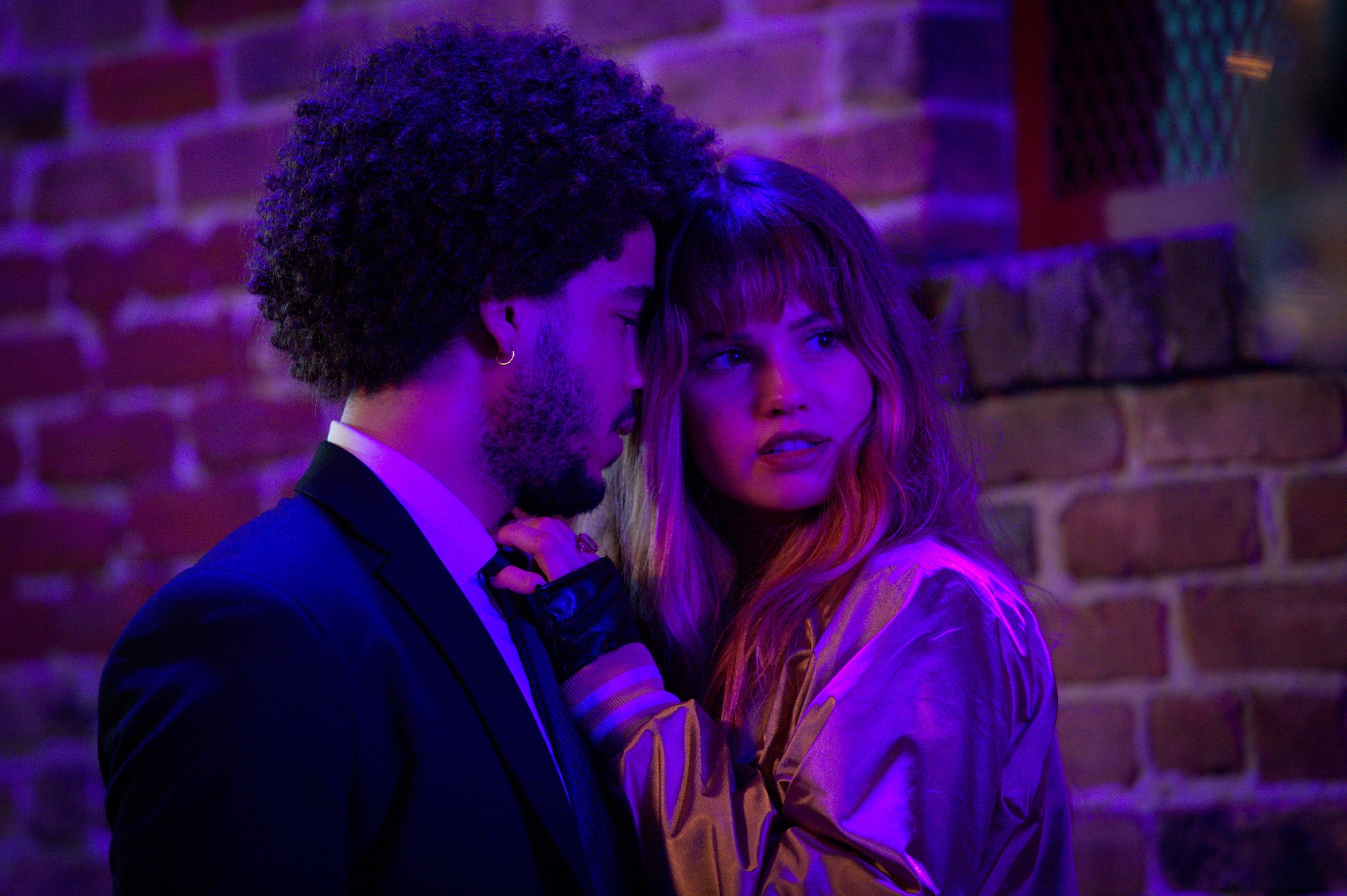 'Night Teeth' stars Jorge Lengeborg Jr. as Benny and Deborah Ryan Papp as Blaire standing close in nightclub lighting