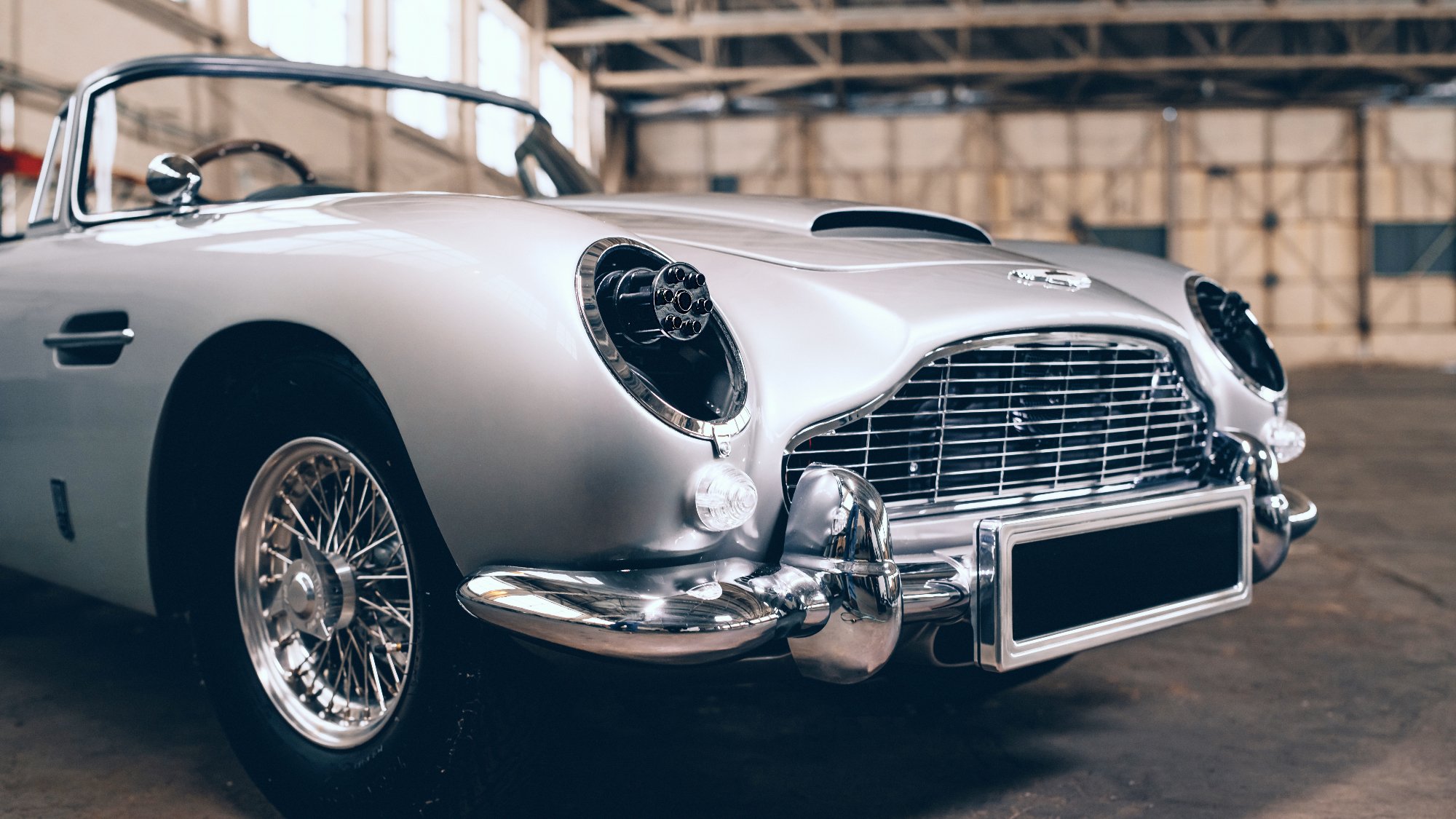 'No Time to Die' James Bond Special Edition Aston Martin DB5 promotional image with toy miniguns behind the headlamps