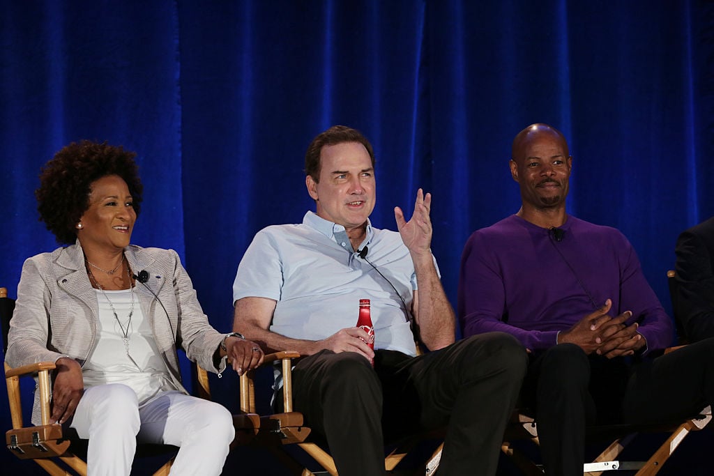 Wanda Sykes, Norm Macdonald, and Keenan Ivory Wayans sit next to each other in chairs while watching auditions. 
