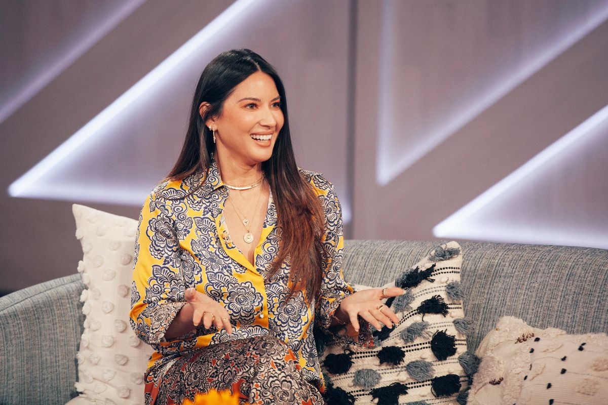 Olivia Munn smiling in yellow