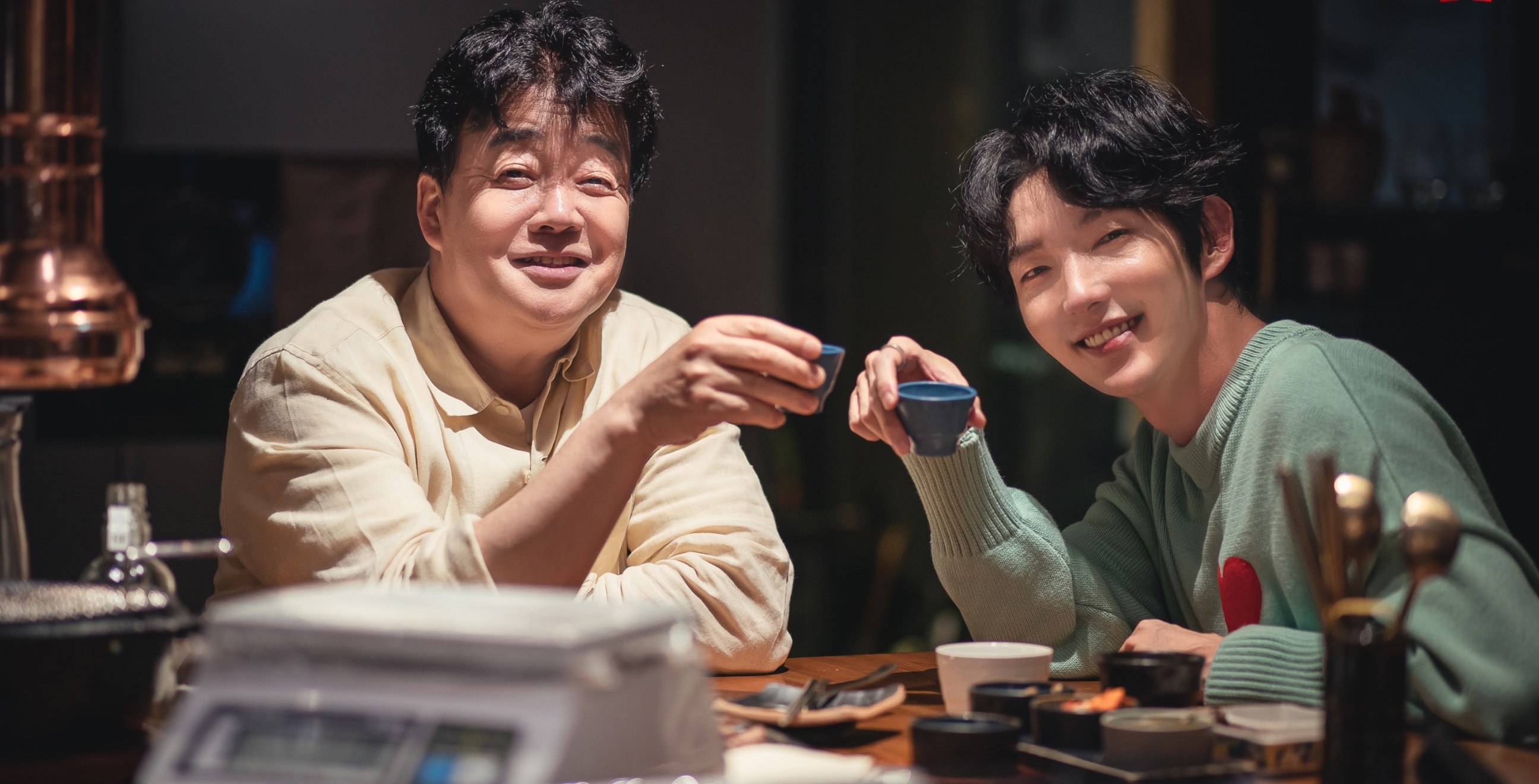 Paik Jong-Won and Lee Joon-Gi for Netflix's 'Paik's Spirit' reality/variety series smiling an cheering drinks.