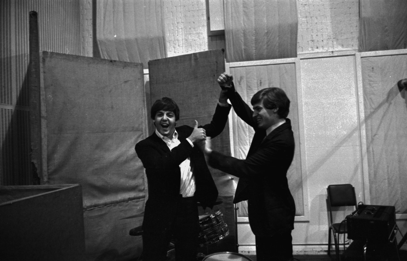 Paul McCartney and his brother Michael McGear in the studio in 1964.