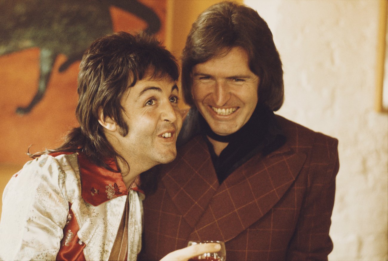 Paul McCartney laughing with his brother Michael McGear in 1974.