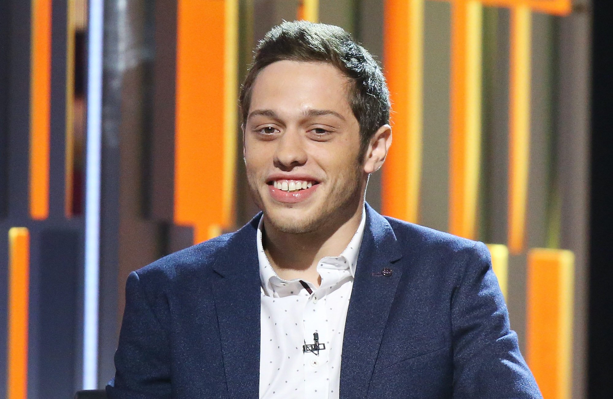Pete Davison smiling in front of a multicolor background