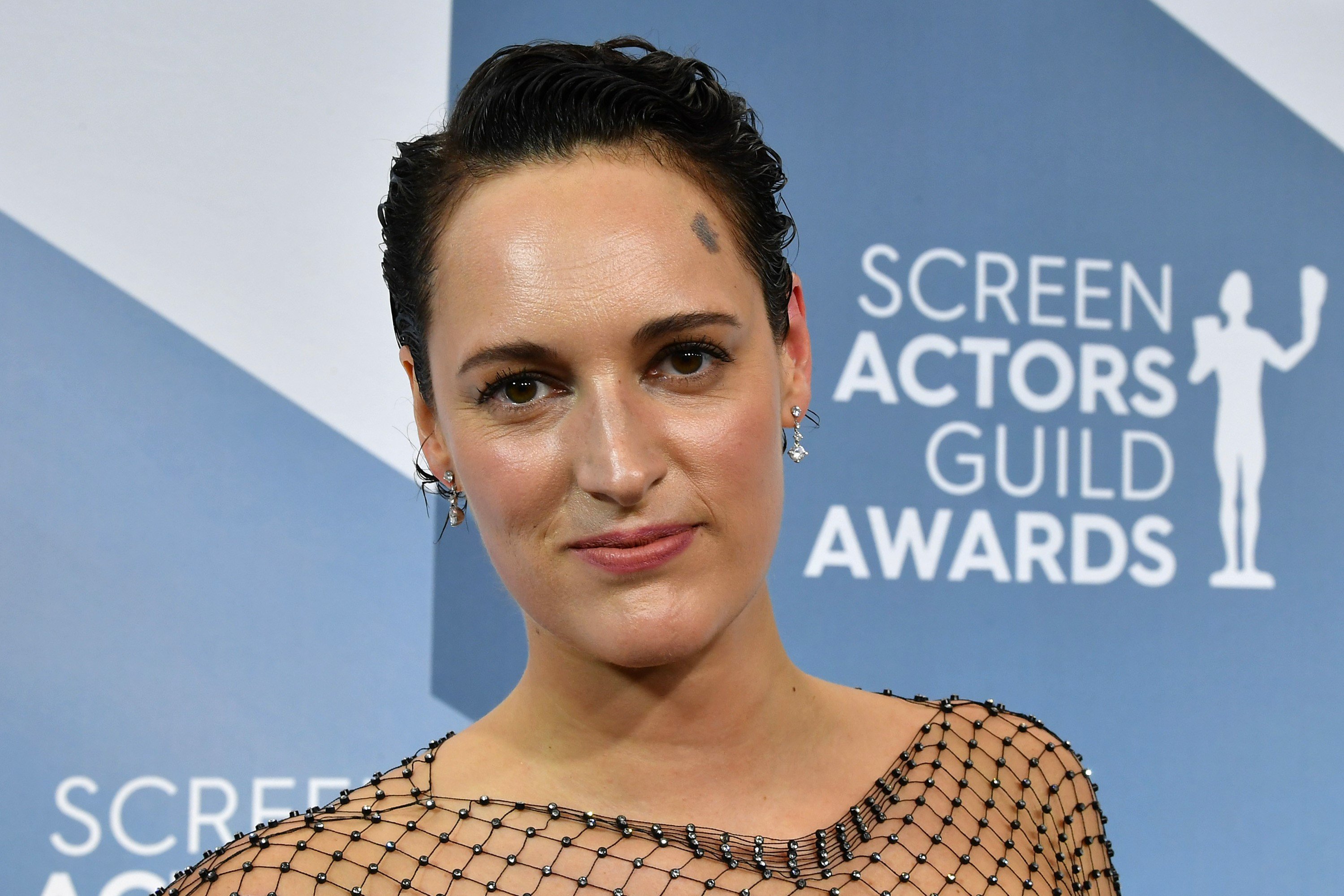 Phoebe Waller-Bridge stands facing the camera in a black dress at the 26th Annual Screen Actors Guild Awards.