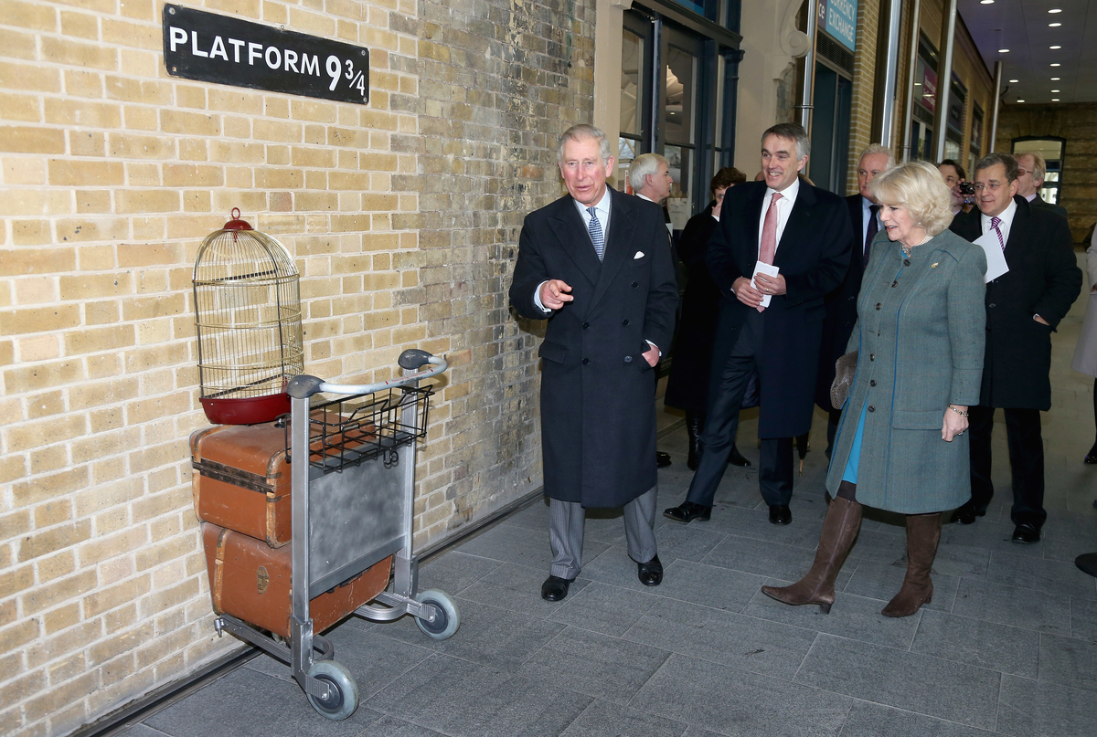 Prince Charles, Prince of Wales and Camilla, Duchess of Cornwall visit platform 9 3/4 at King's Cross Rail Station