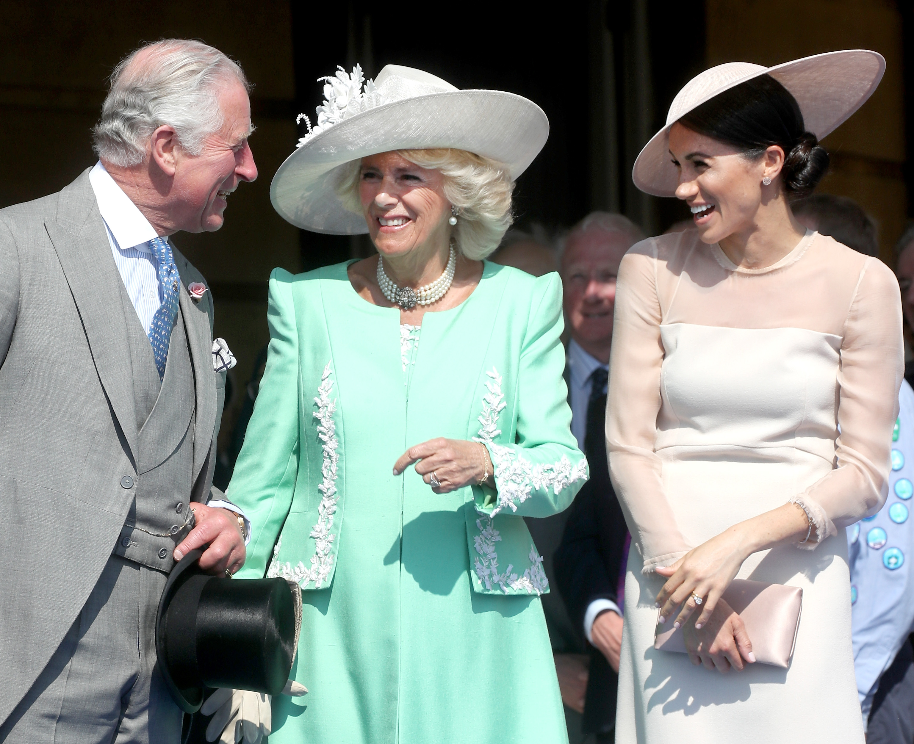 Prince Charles, Camilla Parker Bowles, and Meghan Markle laughing together during Charles' Birthday Patron celebration