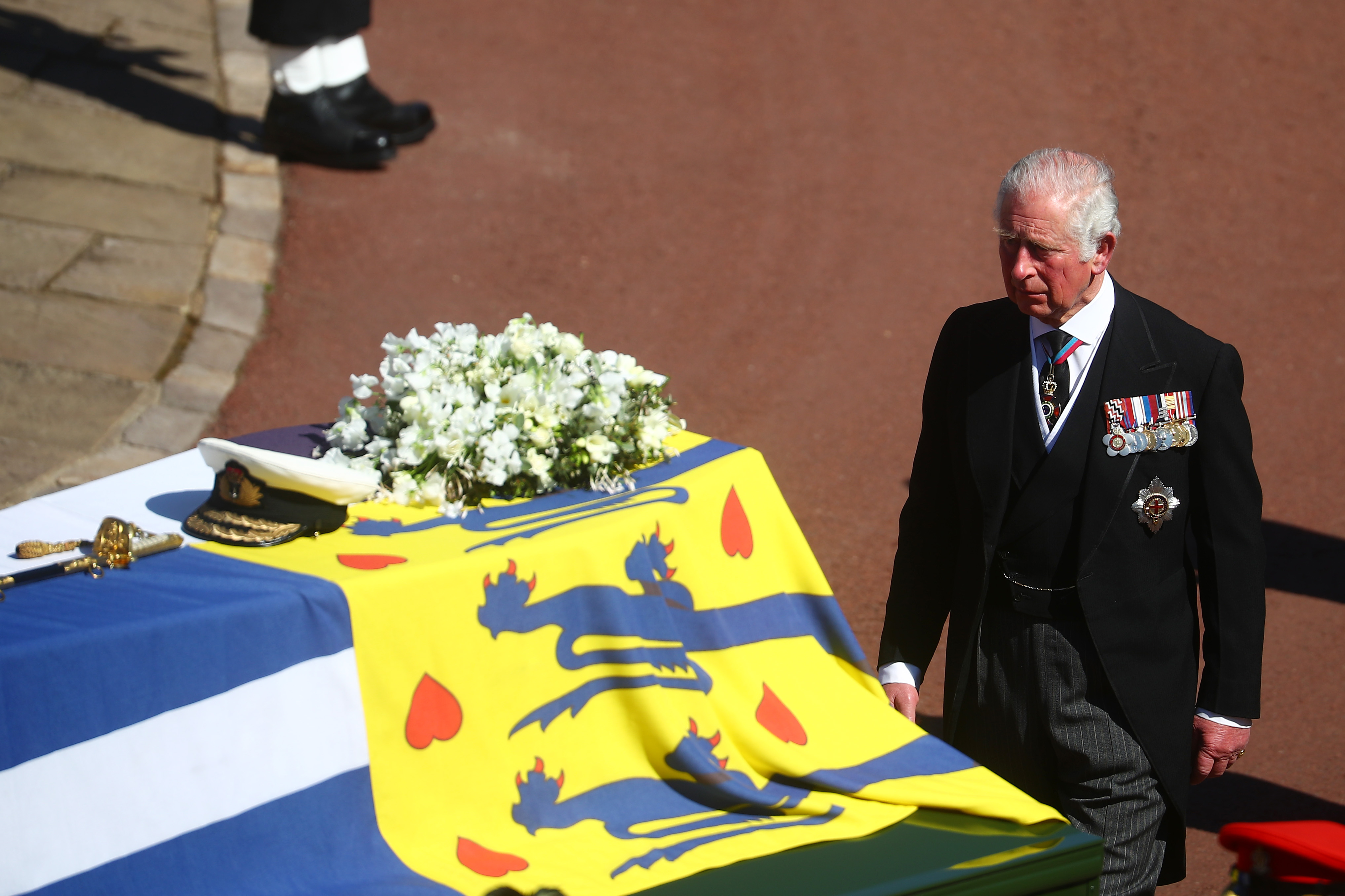 Prince Charles walks behind Prince Philip's coffin, covered with His Royal Highness’s Personal Standard, during Duke of Edinburgh's funeral